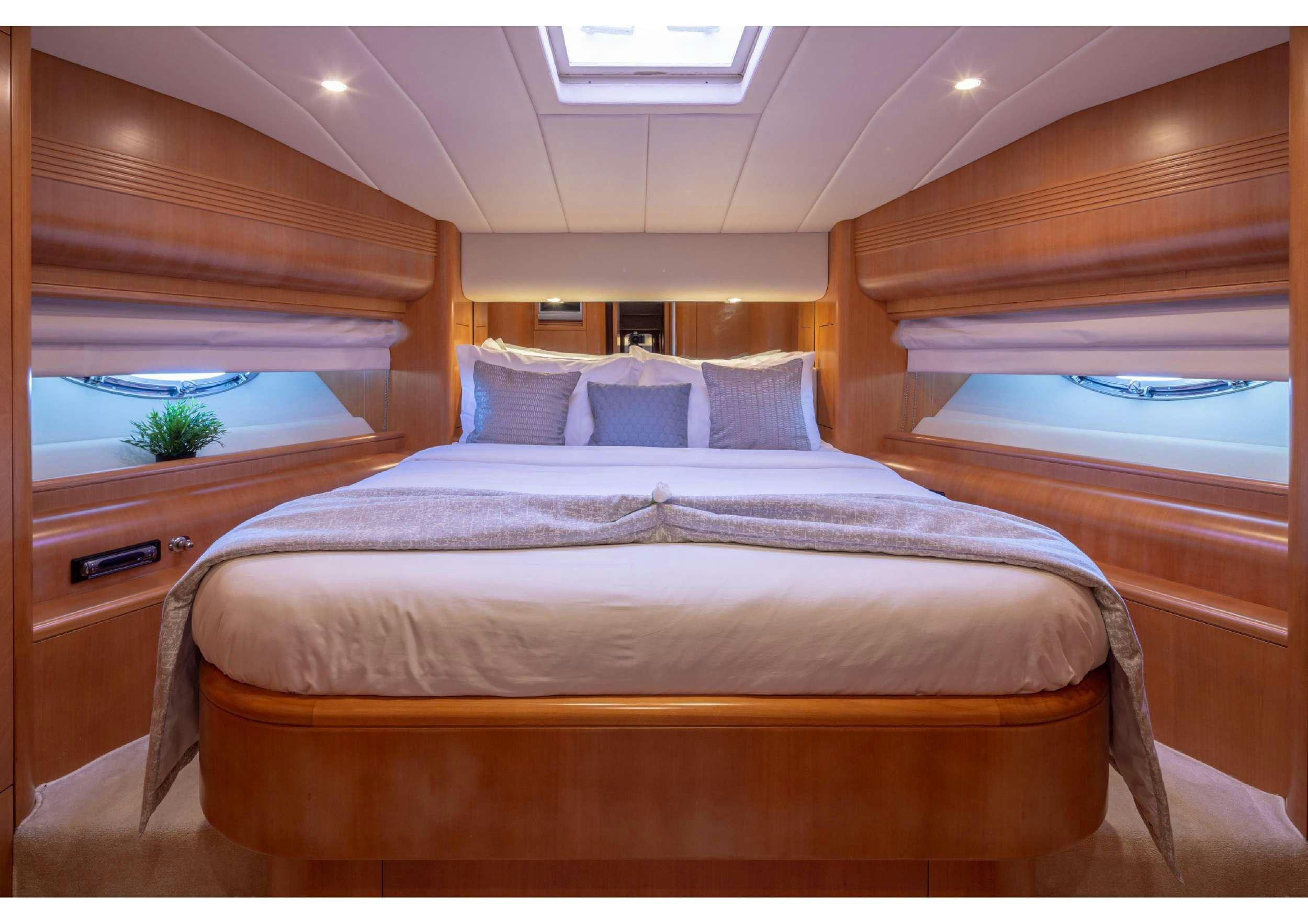 a bed with a wooden headboard aboard LEGEND Yacht for Charter