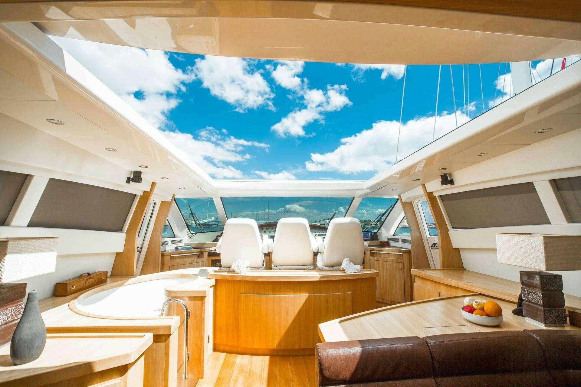 a room with a view of the ocean and the deck aboard DOUBLE D Yacht for Charter