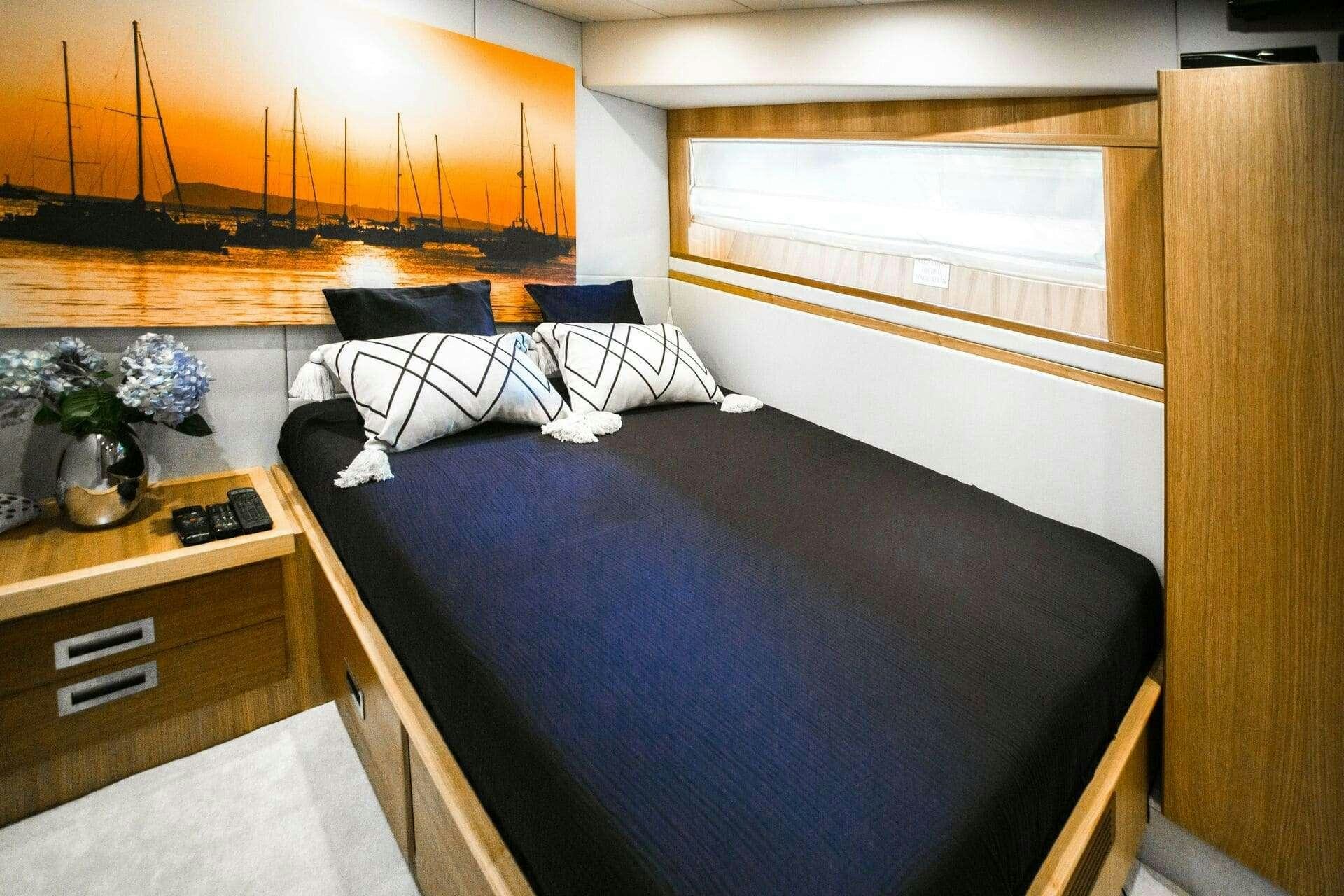 a bed with a blue cover aboard DOUBLE D Yacht for Charter