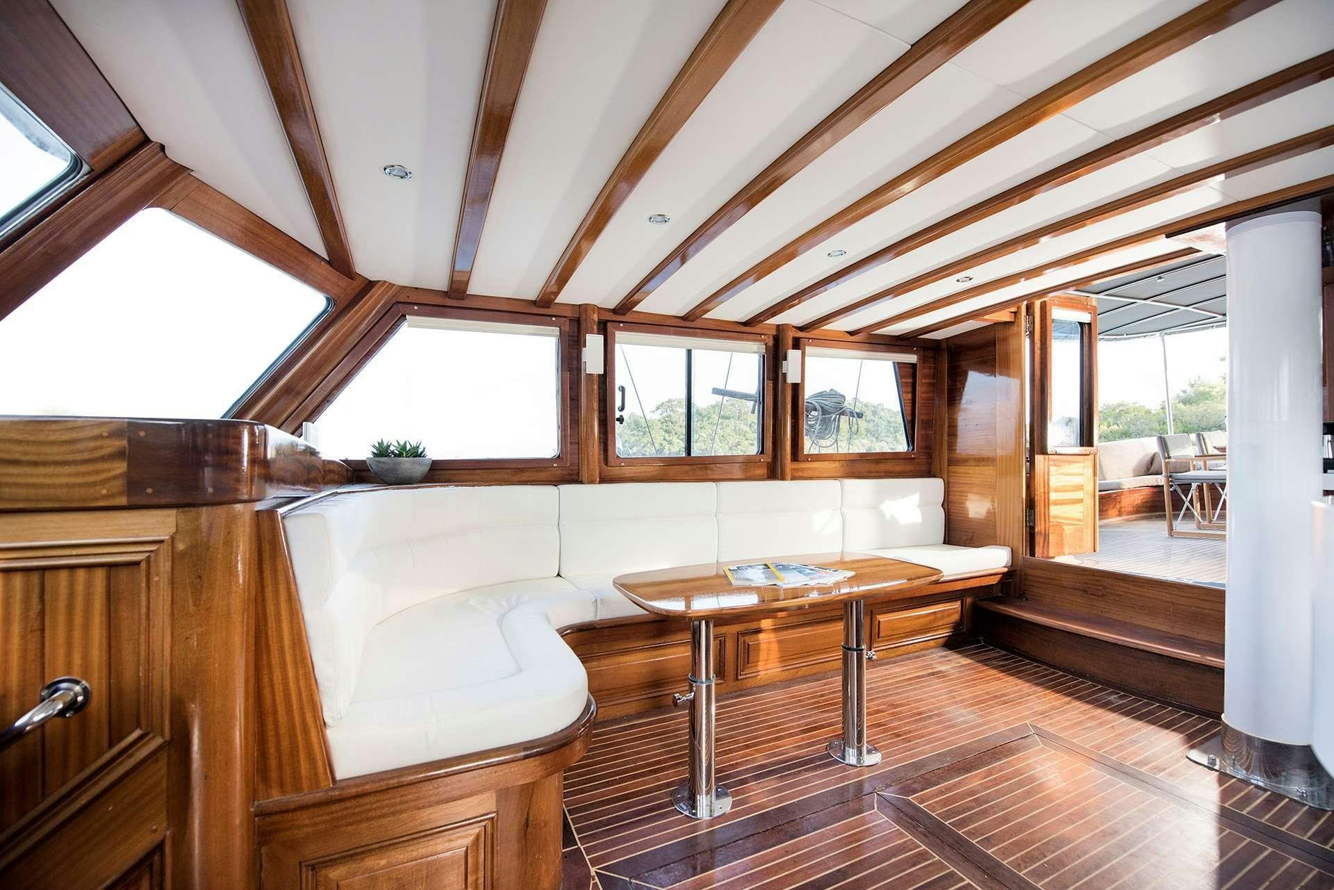 a room with a table and a bed aboard SERENAD A Yacht for Charter