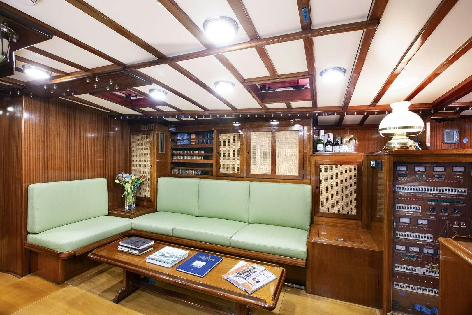 a room with a couch and a coffee table aboard QUARTA SANTA MARIA Yacht for Charter