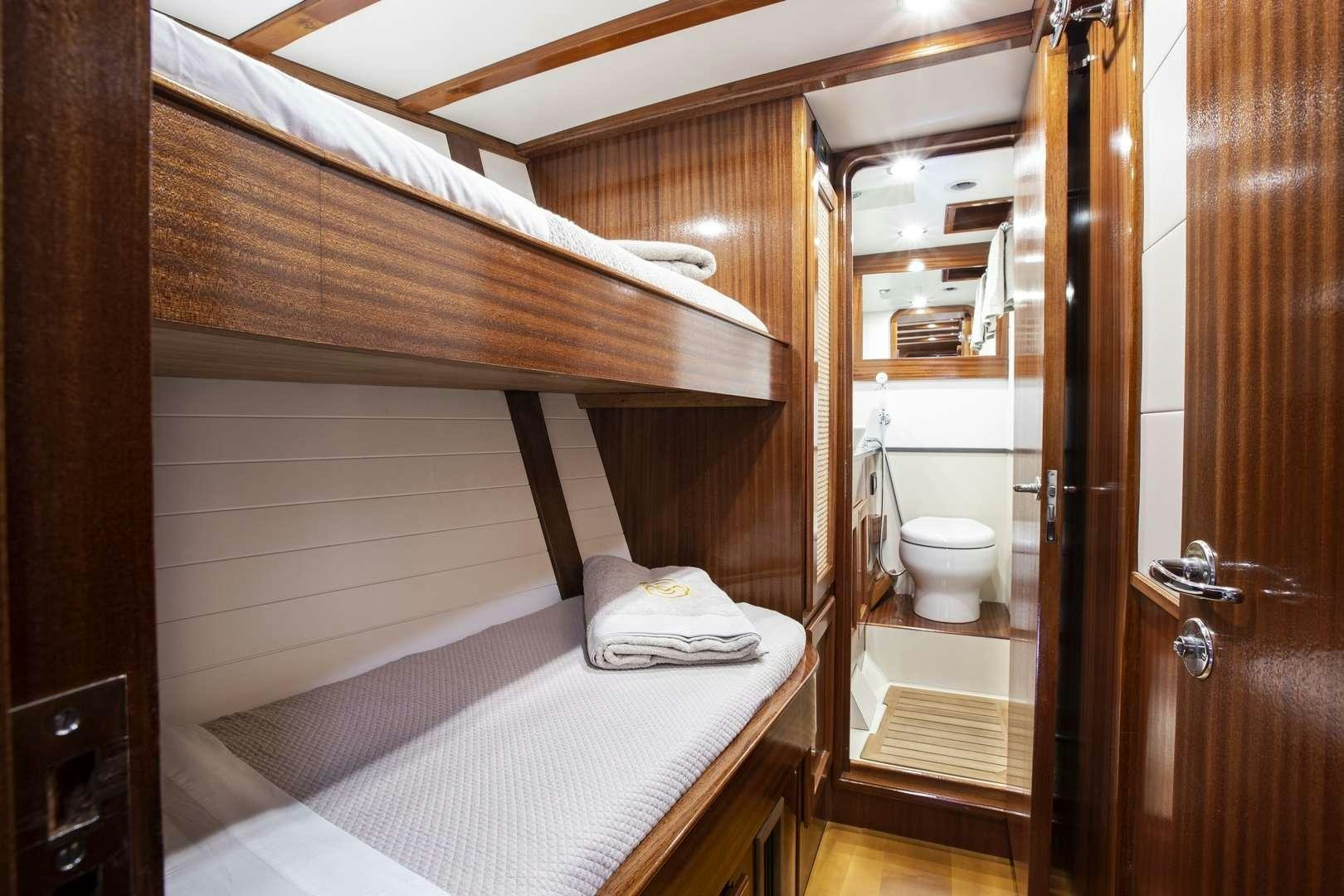 a small bathroom with a wood ceiling aboard QUARTA SANTA MARIA Yacht for Charter