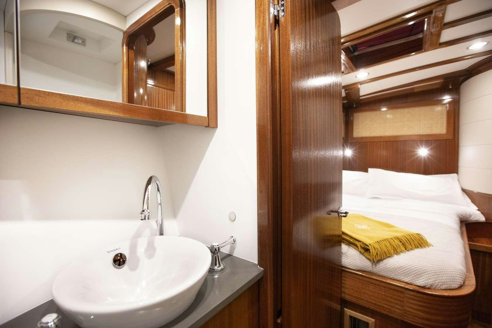 a bathroom with a sink and a mirror aboard QUARTA SANTA MARIA Yacht for Charter