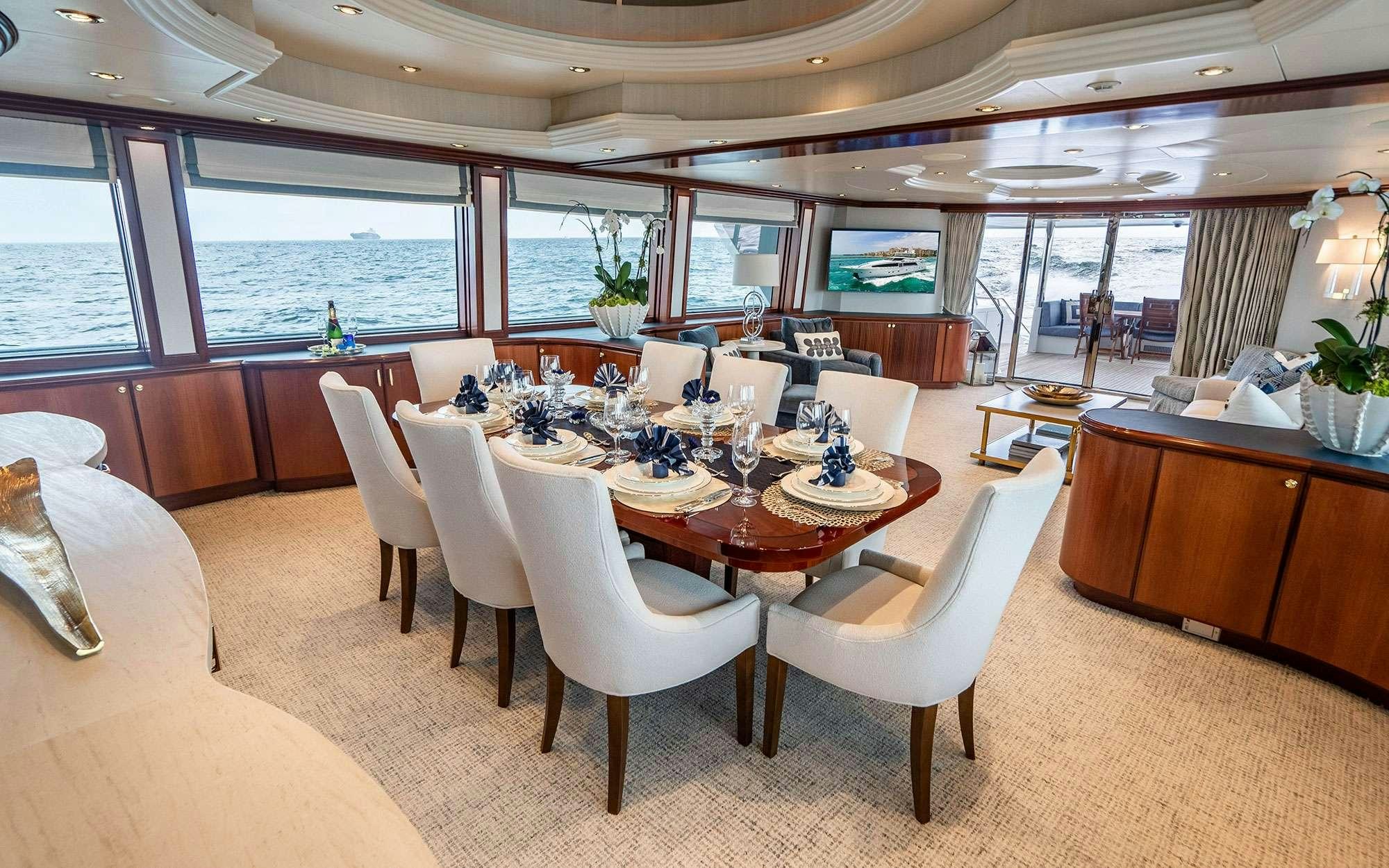 a dining room with a large window aboard RISK & REWARD Yacht for Charter