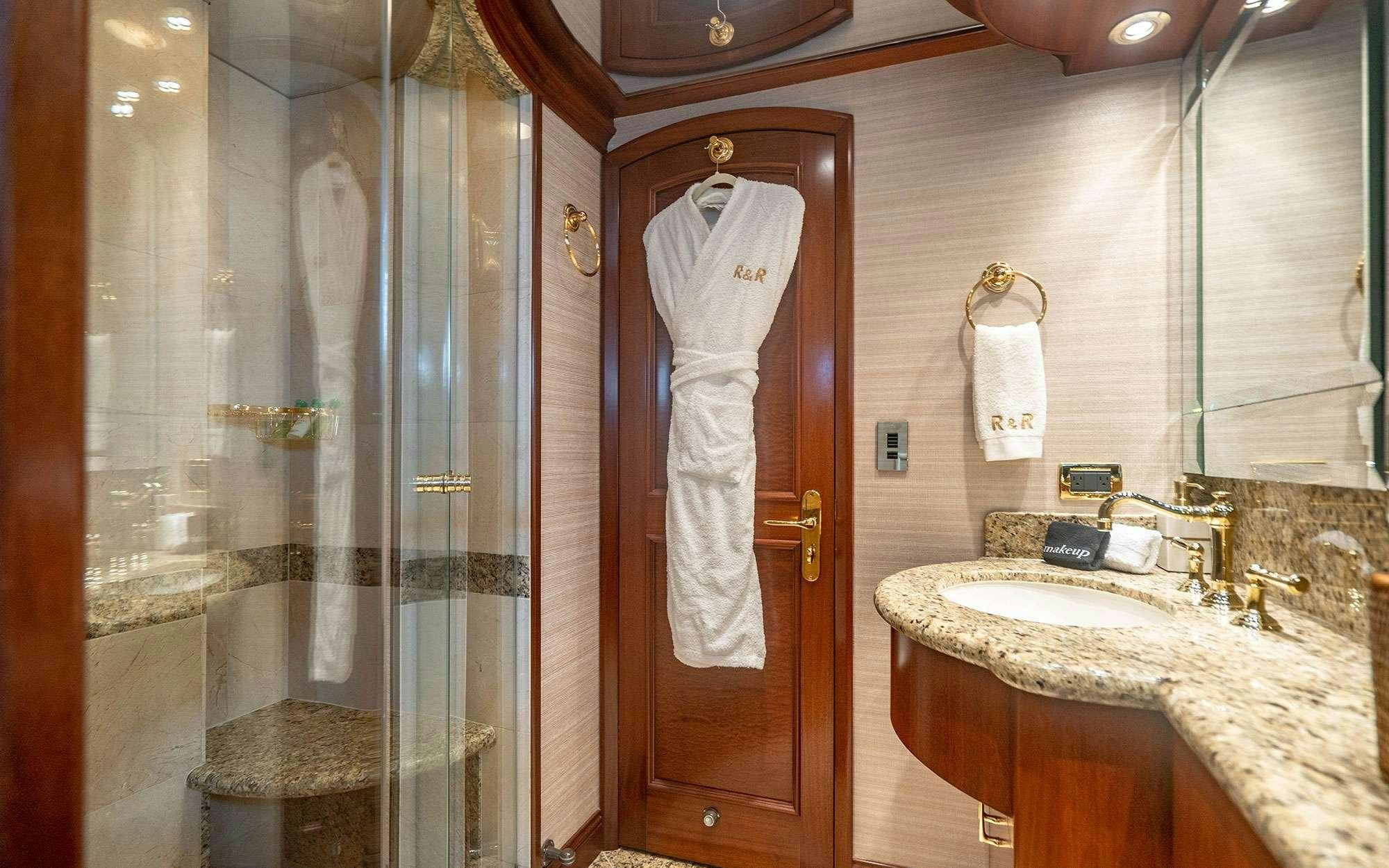 a bathroom with a glass shower aboard RISK & REWARD Yacht for Charter