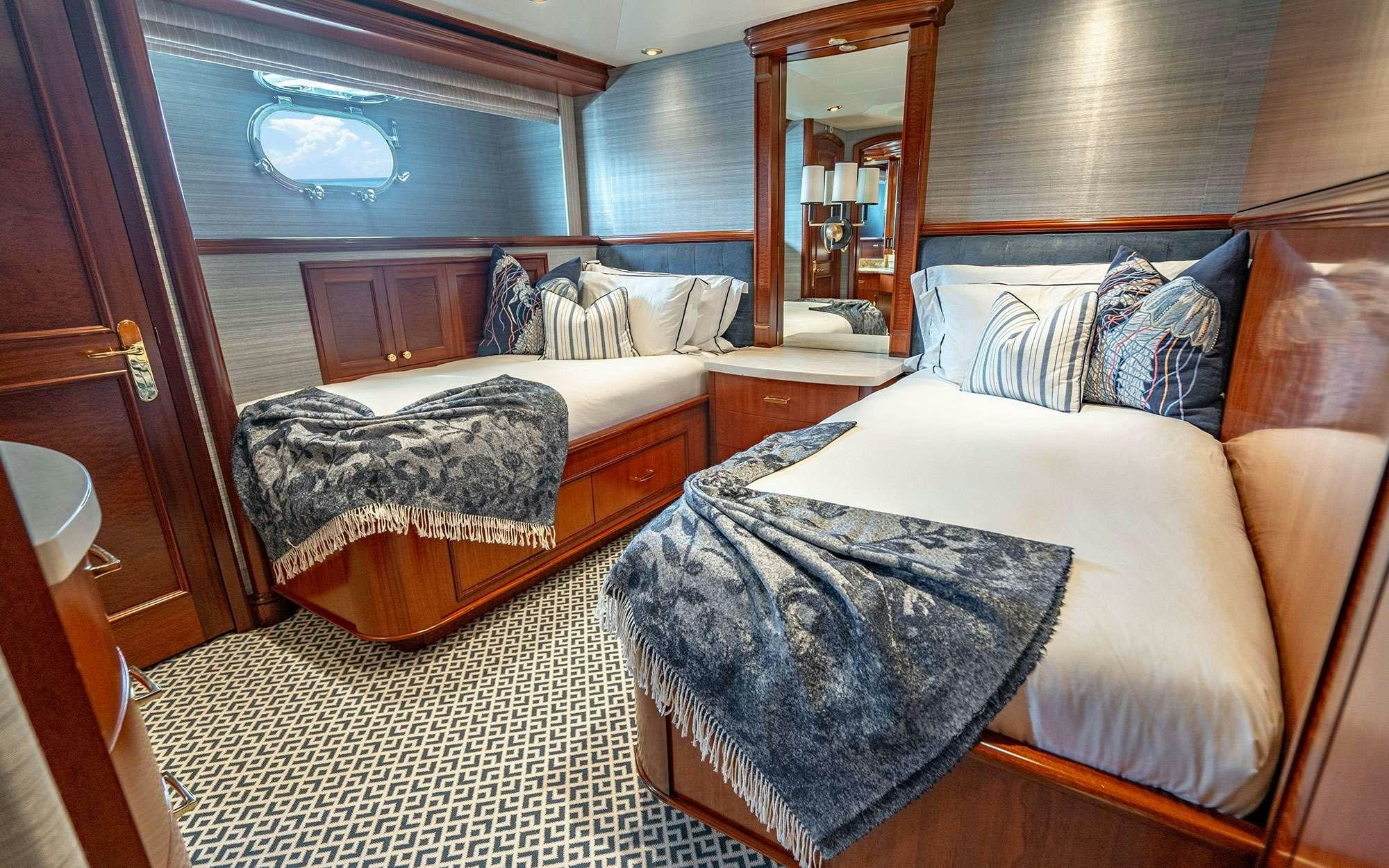 a room with two beds aboard RISK & REWARD Yacht for Charter