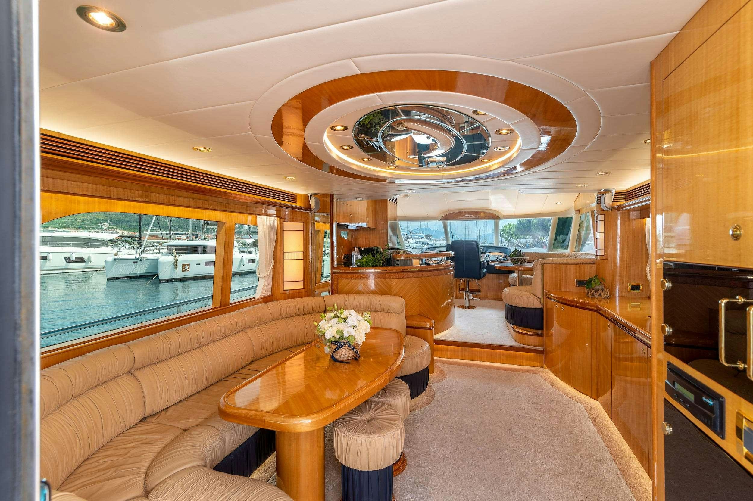 a living room with a large chandelier aboard HAPPY 3 Yacht for Charter
