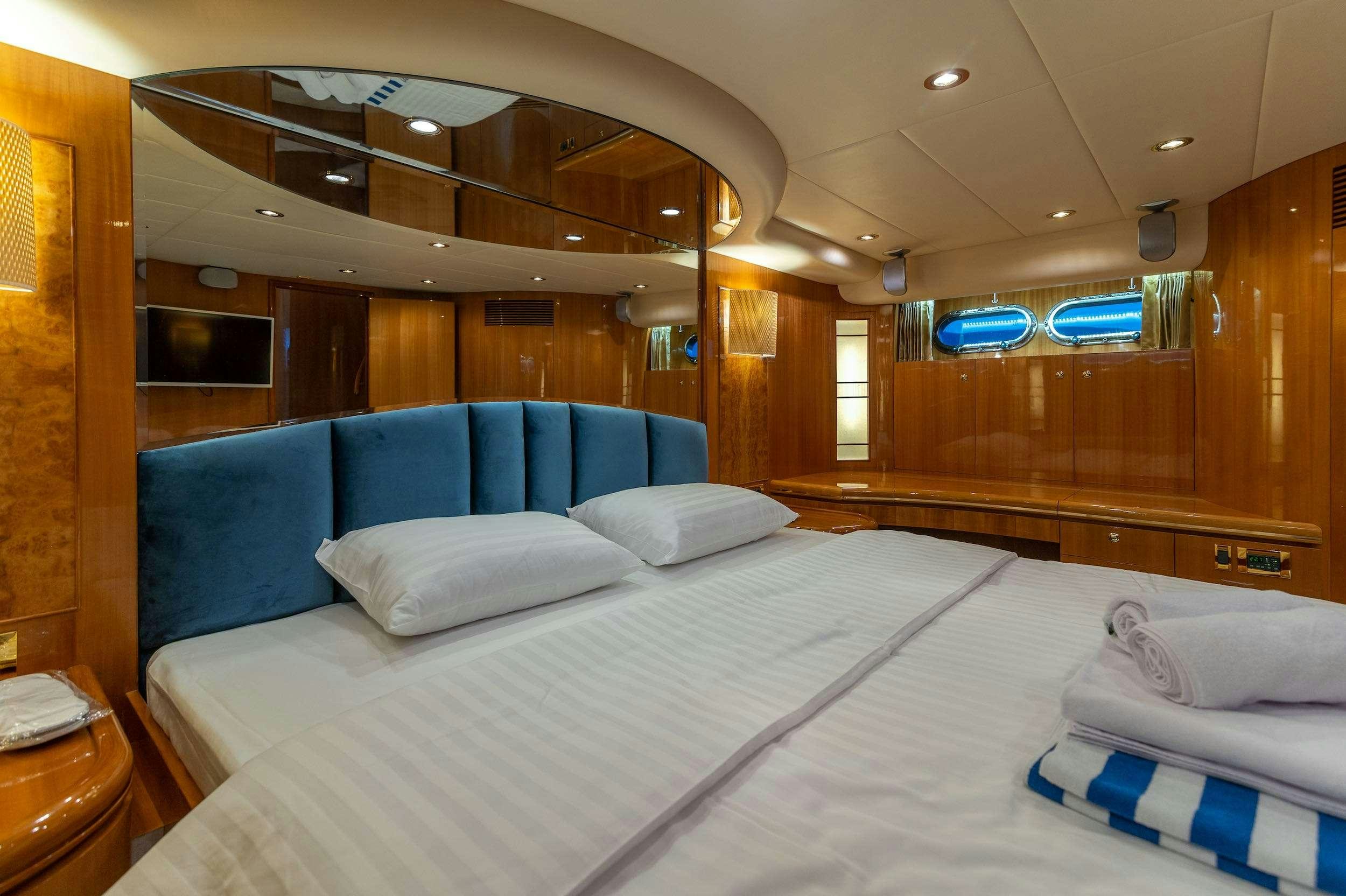 a room with a bed and a couch aboard HAPPY 3 Yacht for Charter
