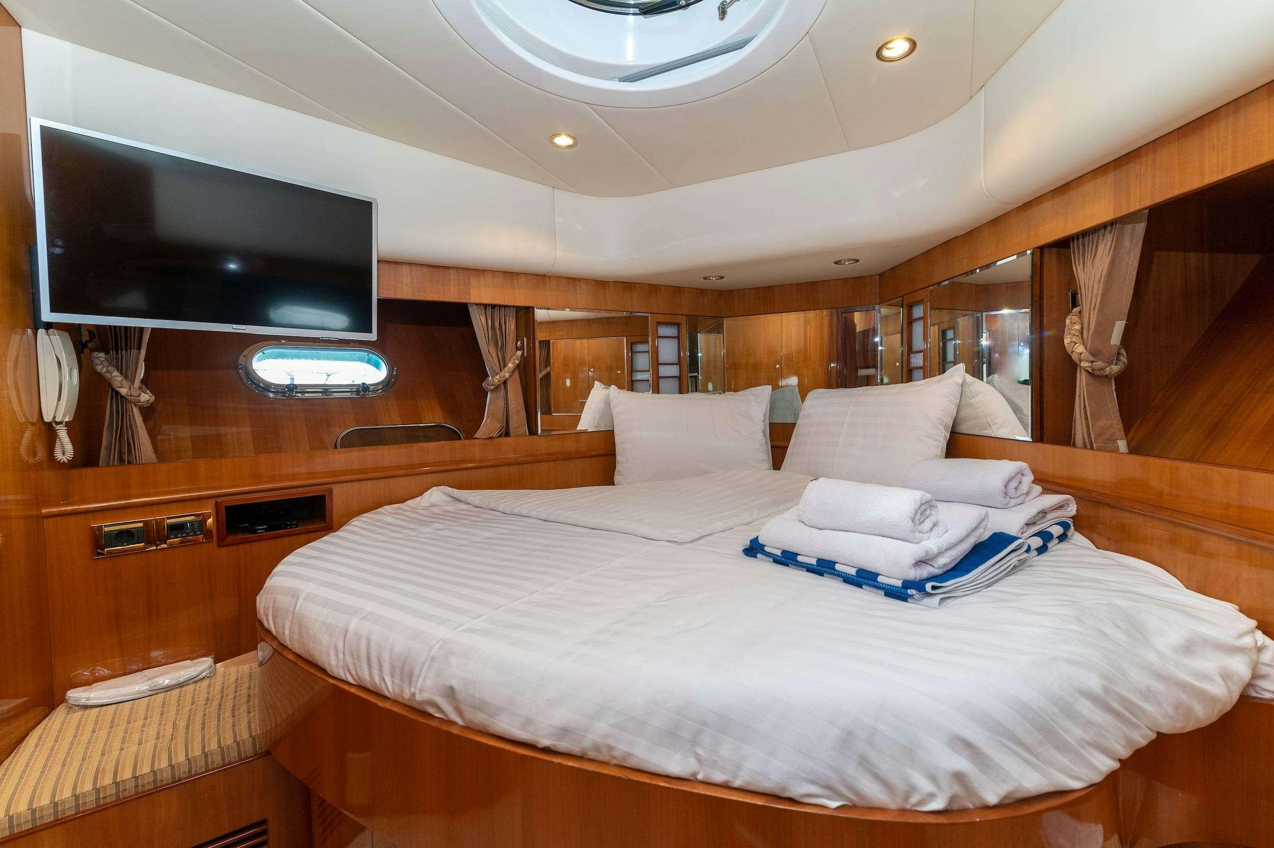 a bed with white sheets aboard HAPPY 3 Yacht for Charter