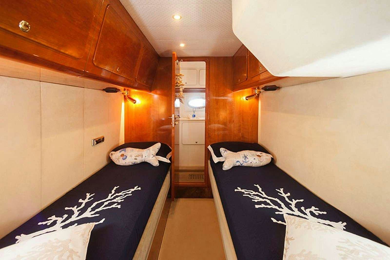 a room with a bed and a closet aboard ARGENT'ARIA Yacht for Charter