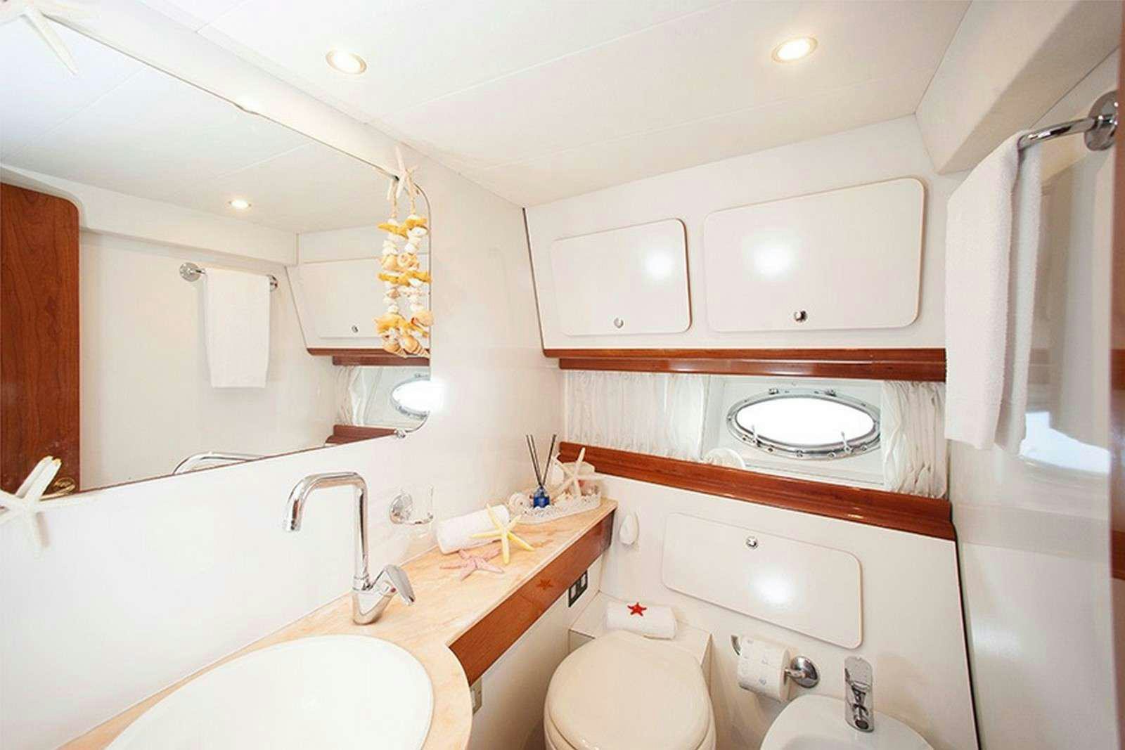 a bathroom with a sink and a mirror aboard ARGENT'ARIA Yacht for Charter