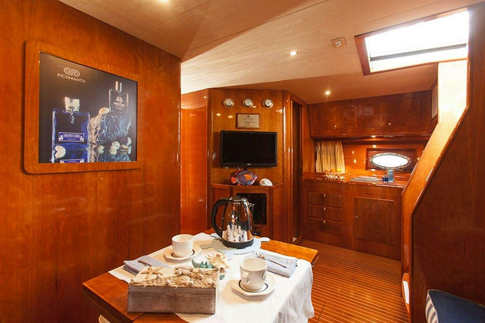 a dining room with a table aboard ARGENT'ARIA Yacht for Charter