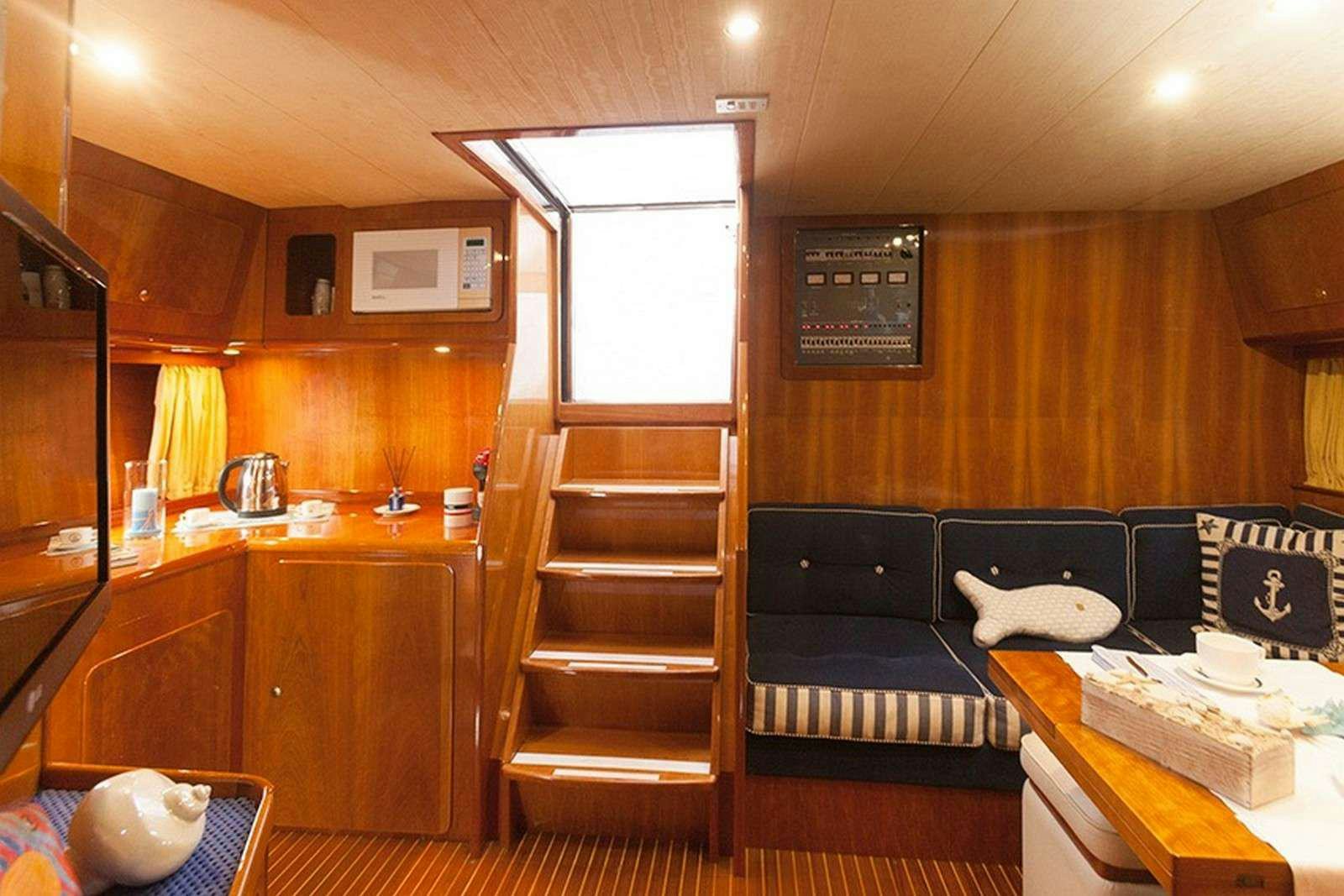 a room with a bed and a couch aboard ARGENT'ARIA Yacht for Charter