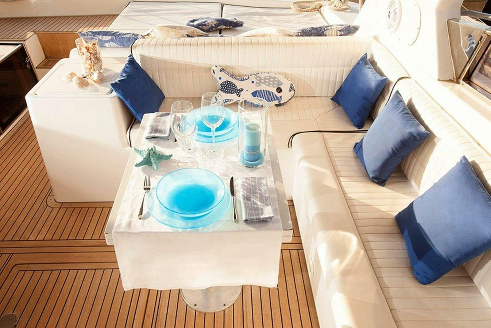 a table with plates and glasses on it aboard ARGENT'ARIA Yacht for Charter