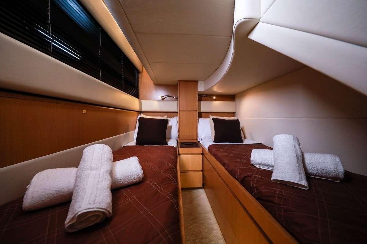 a room with a bed and a couch aboard EVA II Yacht for Charter
