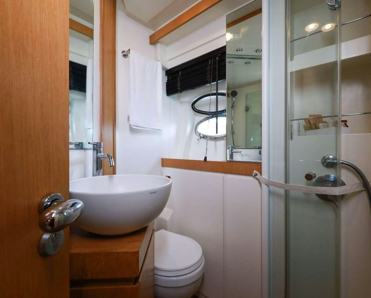 a bathroom with a sink and toilet aboard EVA II Yacht for Charter