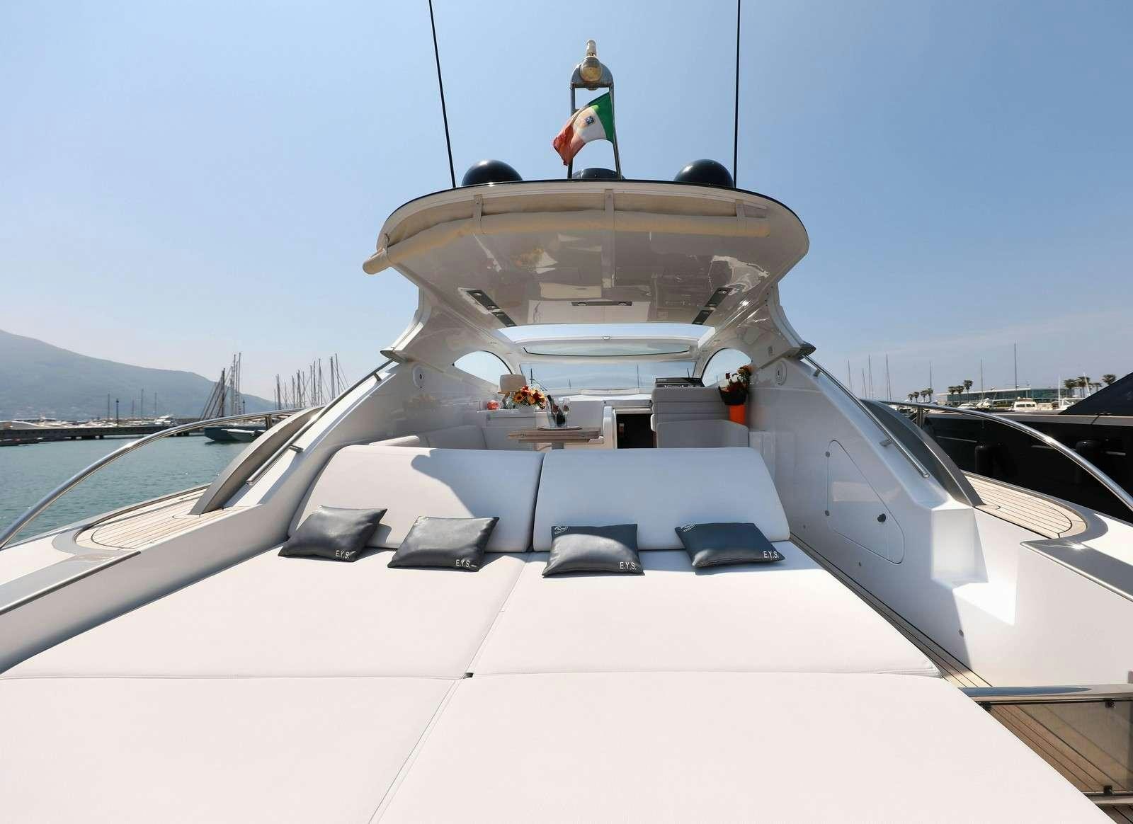 a white yacht with a flag on the front aboard EVA II Yacht for Charter