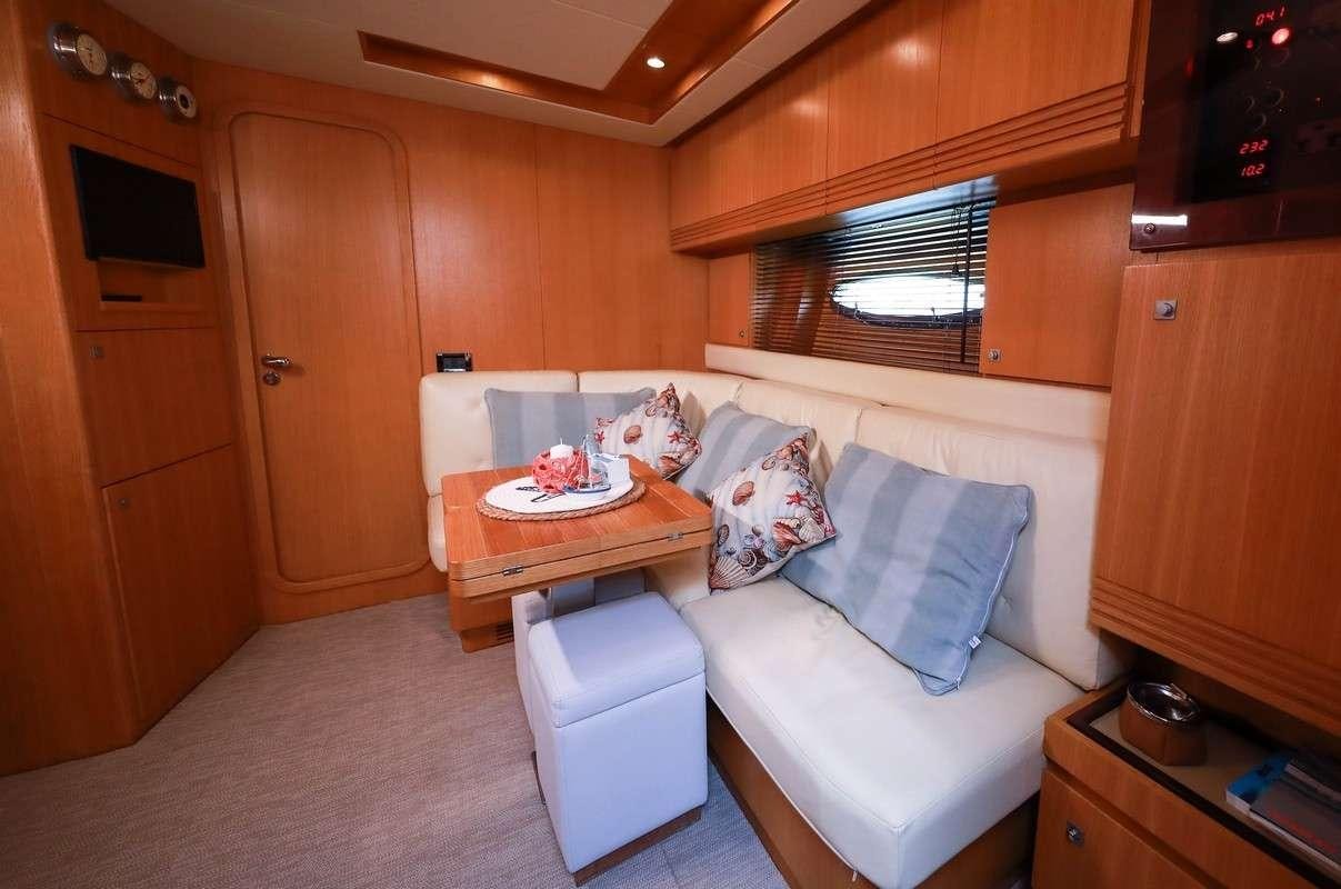 a living room with a couch and a table aboard EVA II Yacht for Charter