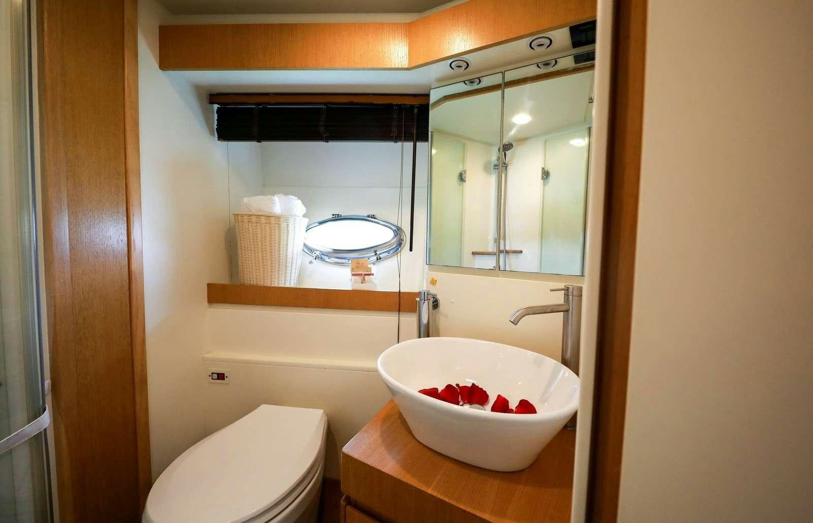a bathroom with a sink and a mirror aboard EVA II Yacht for Charter