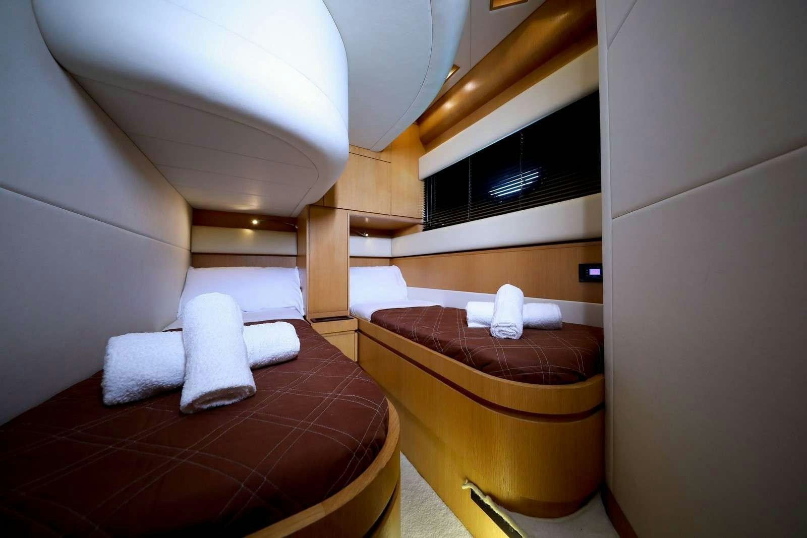 a room with a bed and a desk aboard EVA II Yacht for Charter