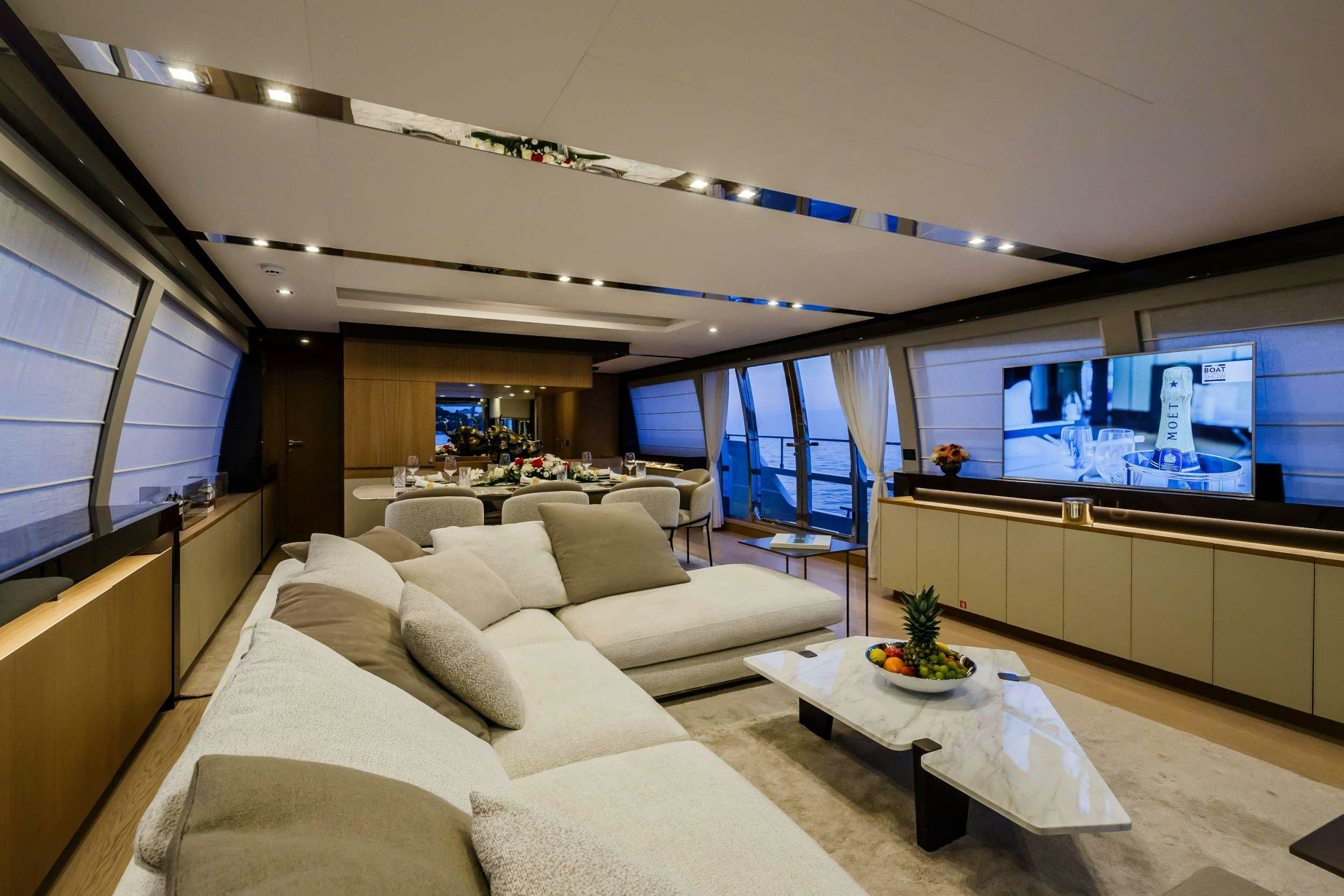 a living room with a large window aboard DAMARI Yacht for Charter