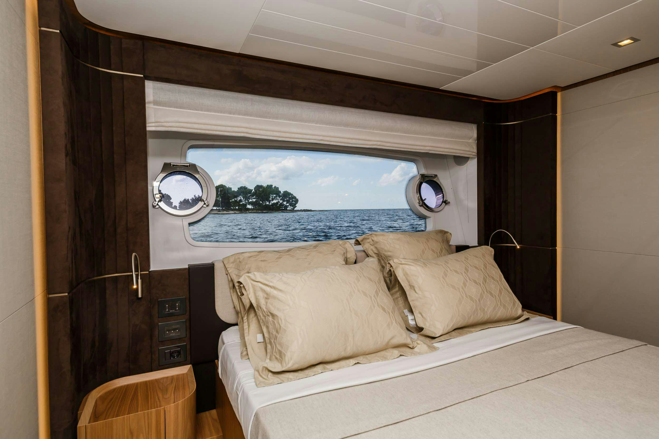 a room with a bed and a window aboard DAMARI Yacht for Charter