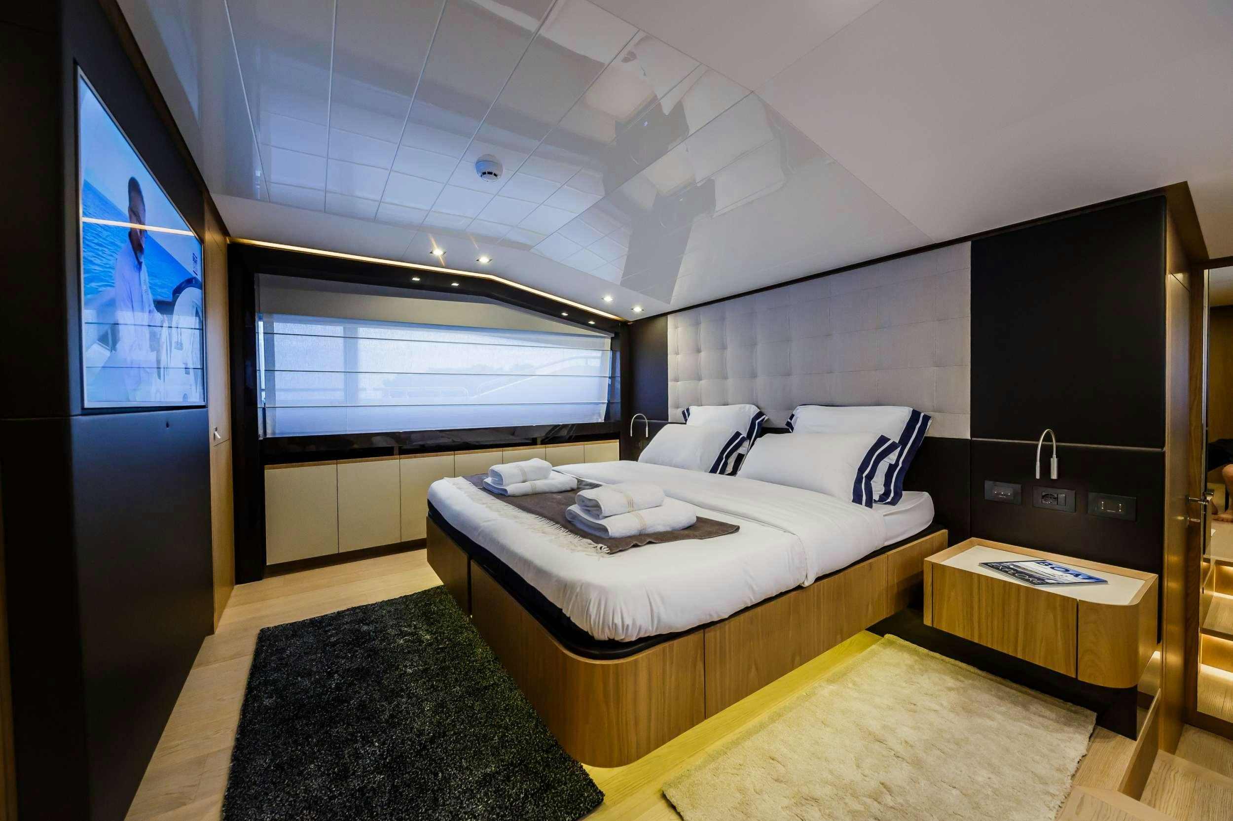 a room with a bed and a desk aboard DAMARI Yacht for Charter
