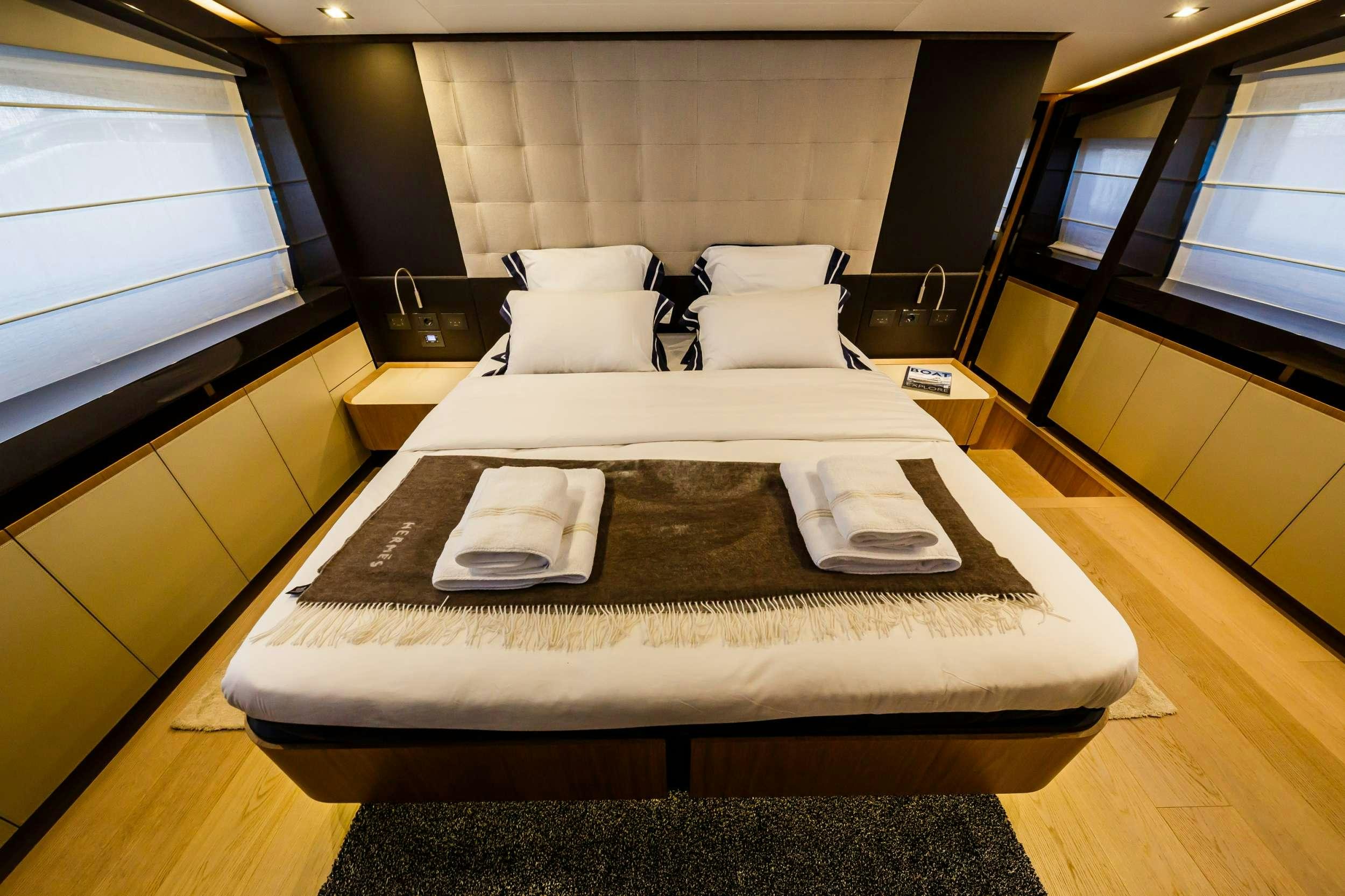 a bed with a tray on it aboard DAMARI Yacht for Charter