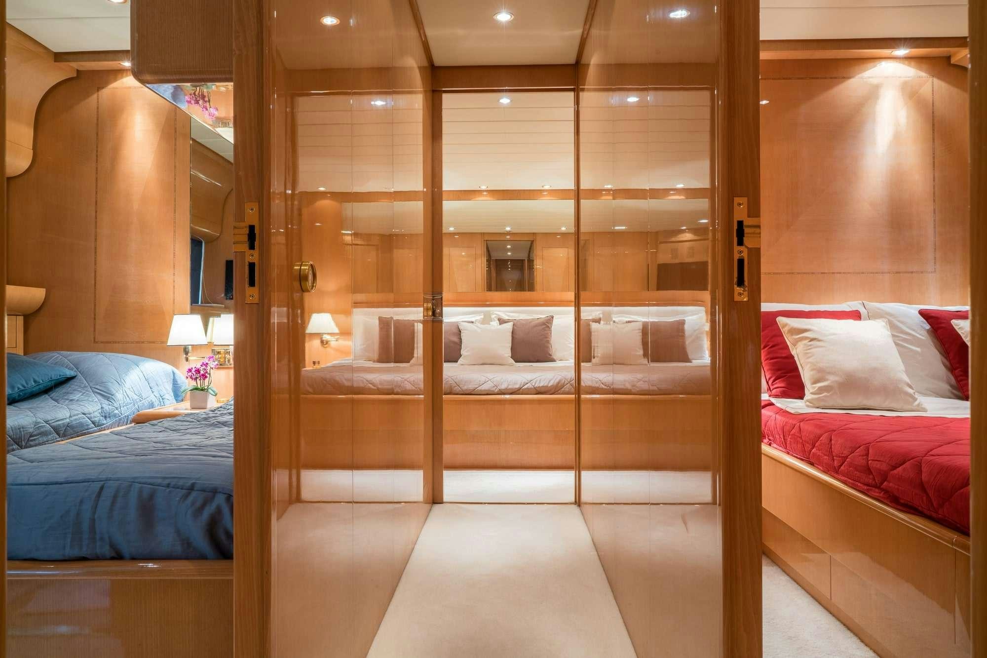 a room with a bed and a mirror aboard ROMACHRIS II Yacht for Charter