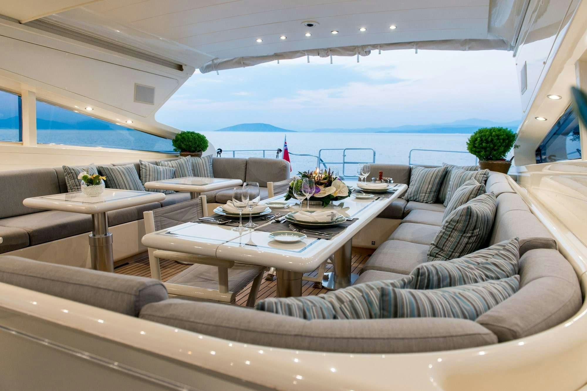 a living room with a large patio aboard ROMACHRIS II Yacht for Charter