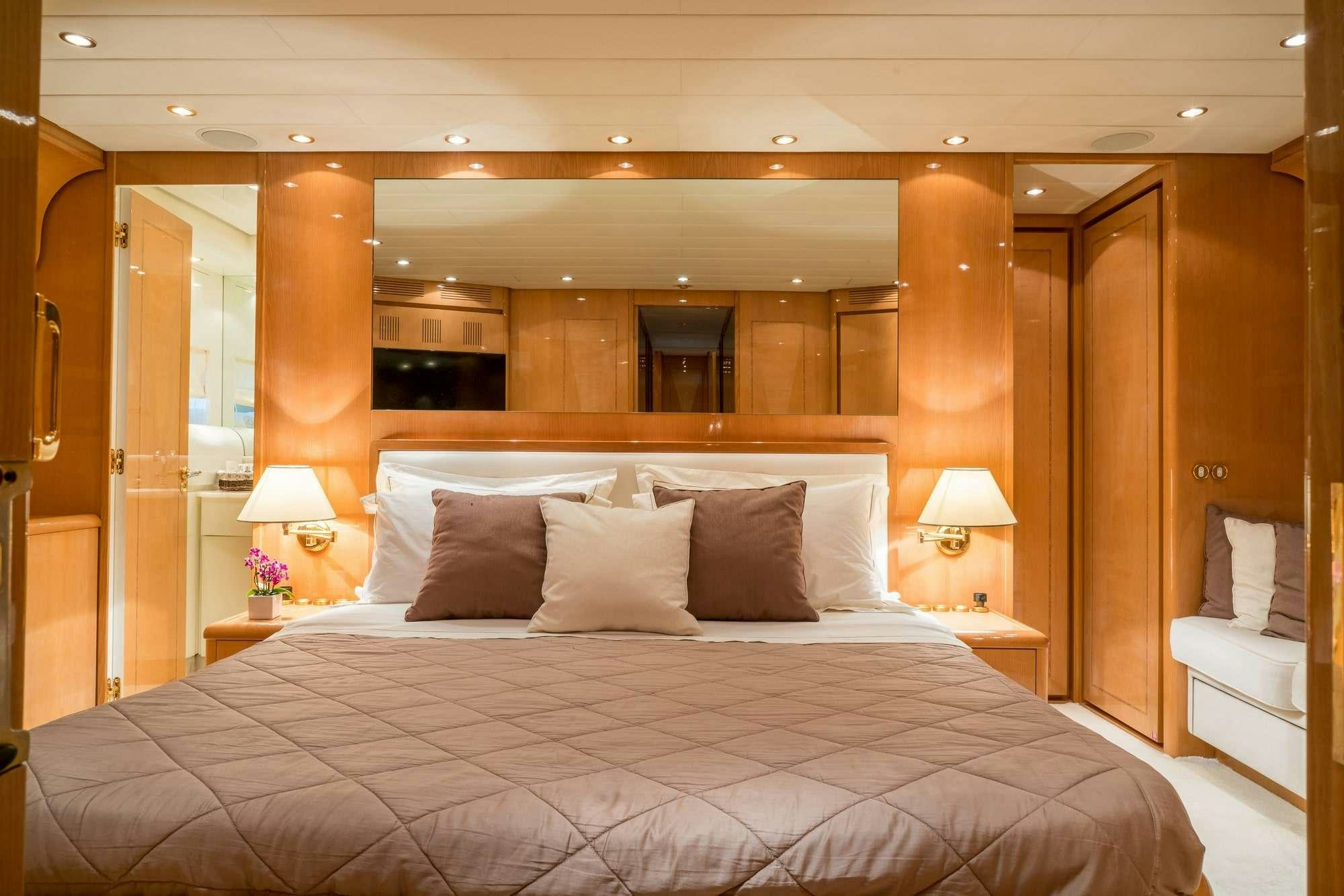 a bed with a white bed spread aboard ROMACHRIS II Yacht for Charter