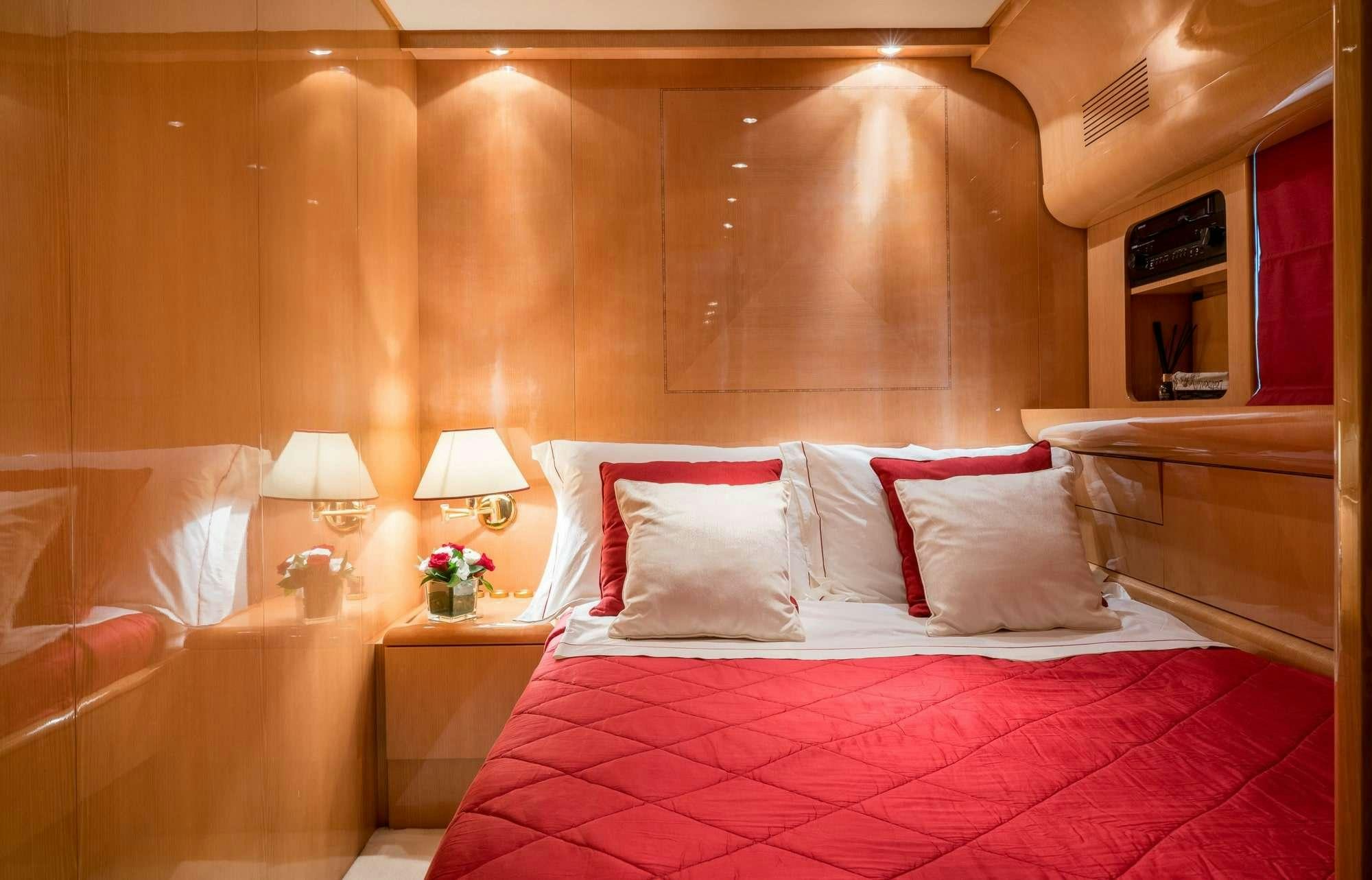 a bed with pink and white pillows aboard ROMACHRIS II Yacht for Charter