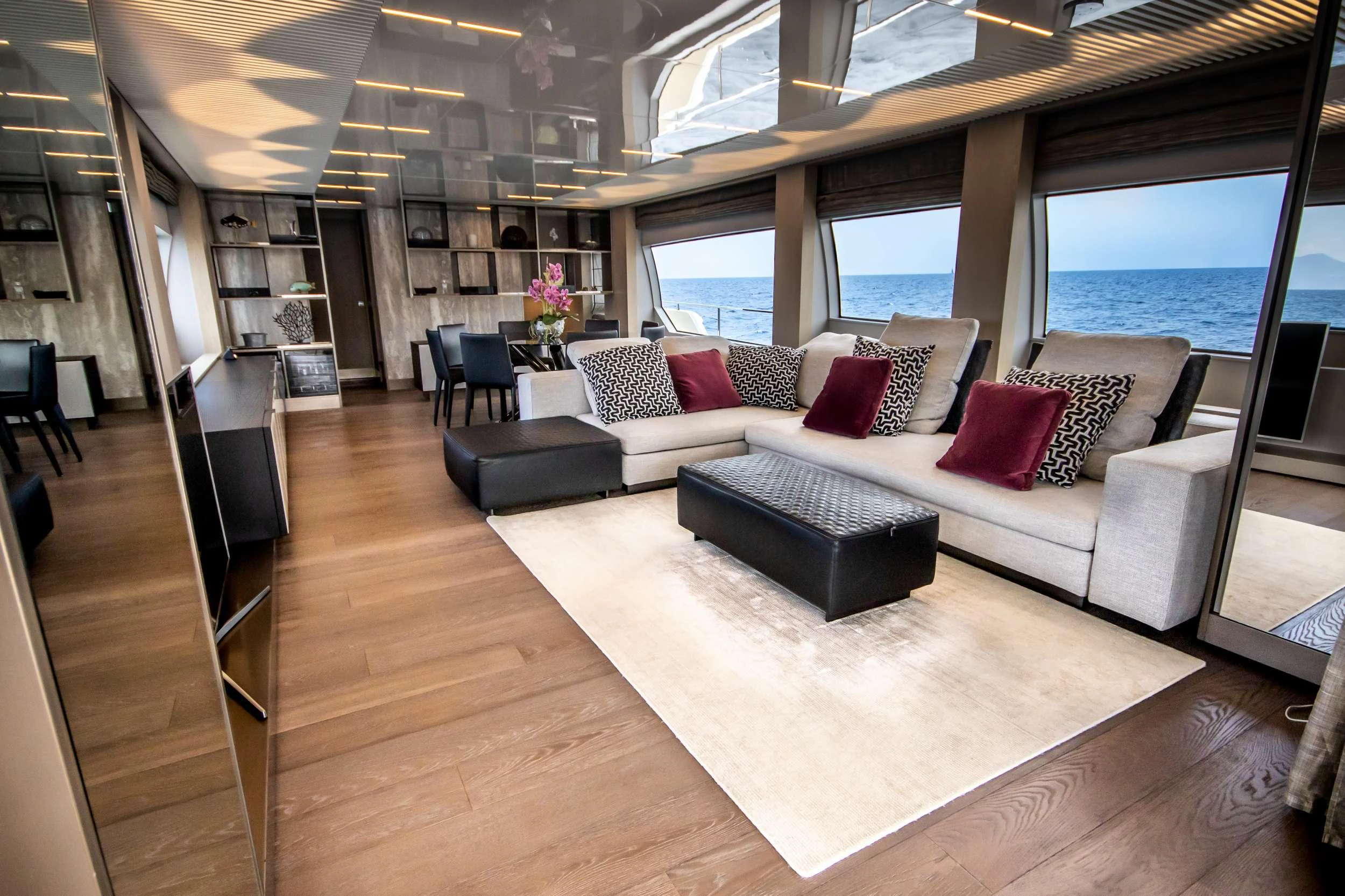 a living room with a large window aboard E3 Yacht for Charter