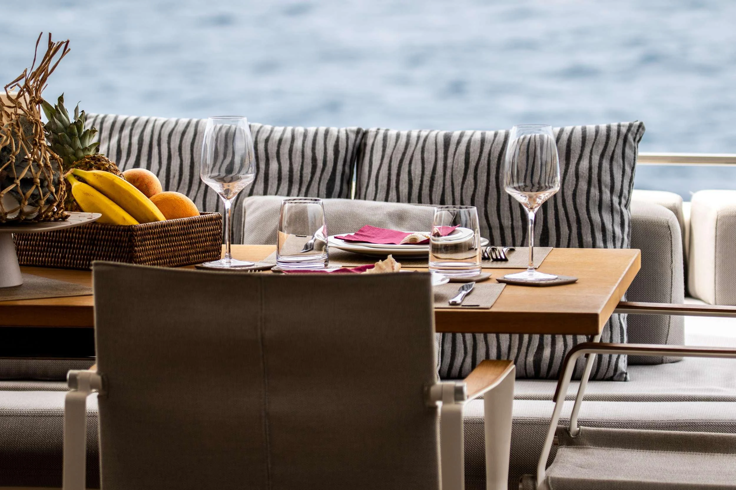 a table with a basket of fruit on it aboard E3 Yacht for Charter