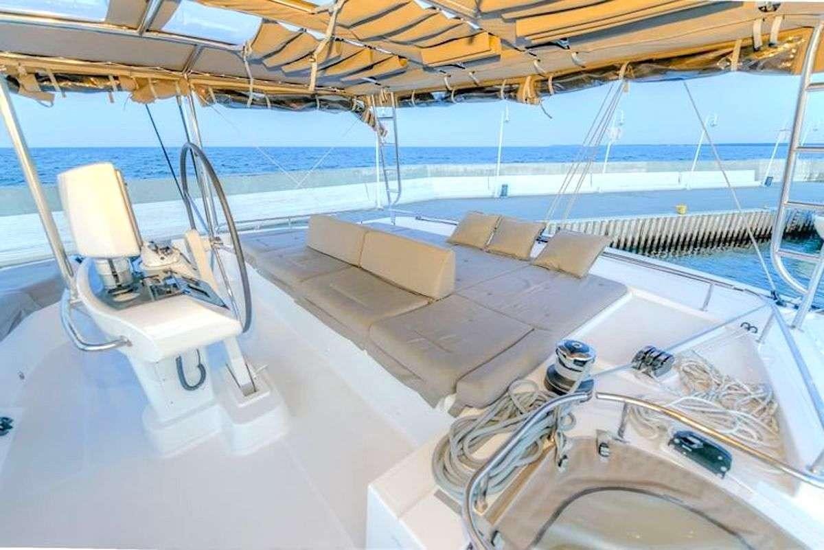 a large white boat with a deck aboard GEMMA Yacht for Charter