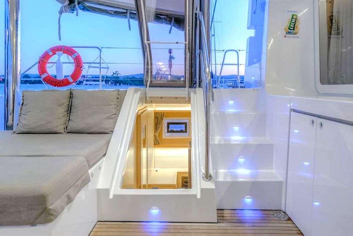 a room with a couch and a window aboard GEMMA Yacht for Charter