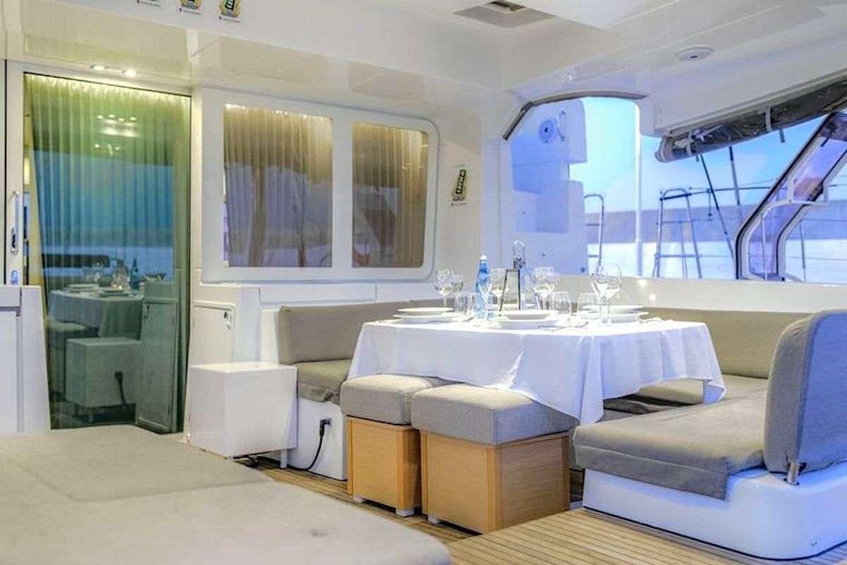 a room with a table and chairs aboard GEMMA Yacht for Charter