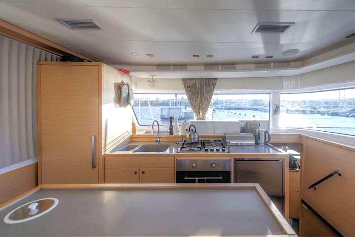 a kitchen with a sink and cabinets aboard GEMMA Yacht for Charter