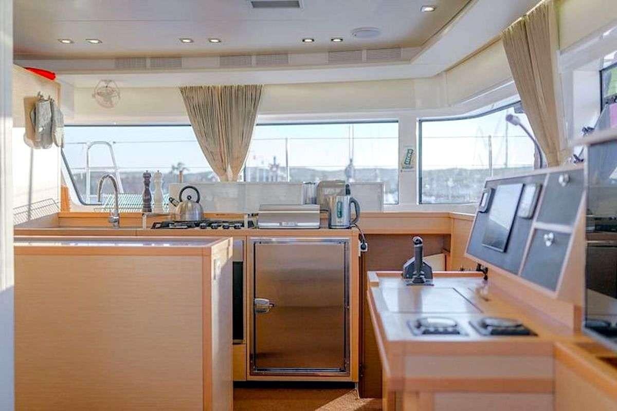 a kitchen with a microwave oven and a sink aboard GEMMA Yacht for Charter