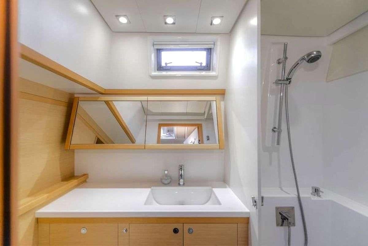 a bathroom with a sink and a shower aboard GEMMA Yacht for Charter