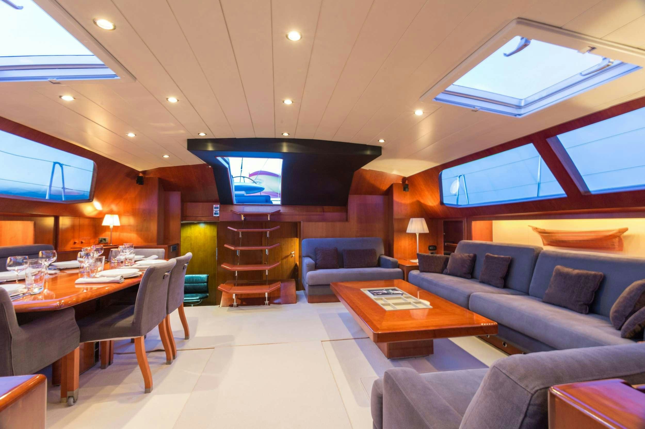 a living room with a couch and a table aboard Free at Last Yacht for Charter