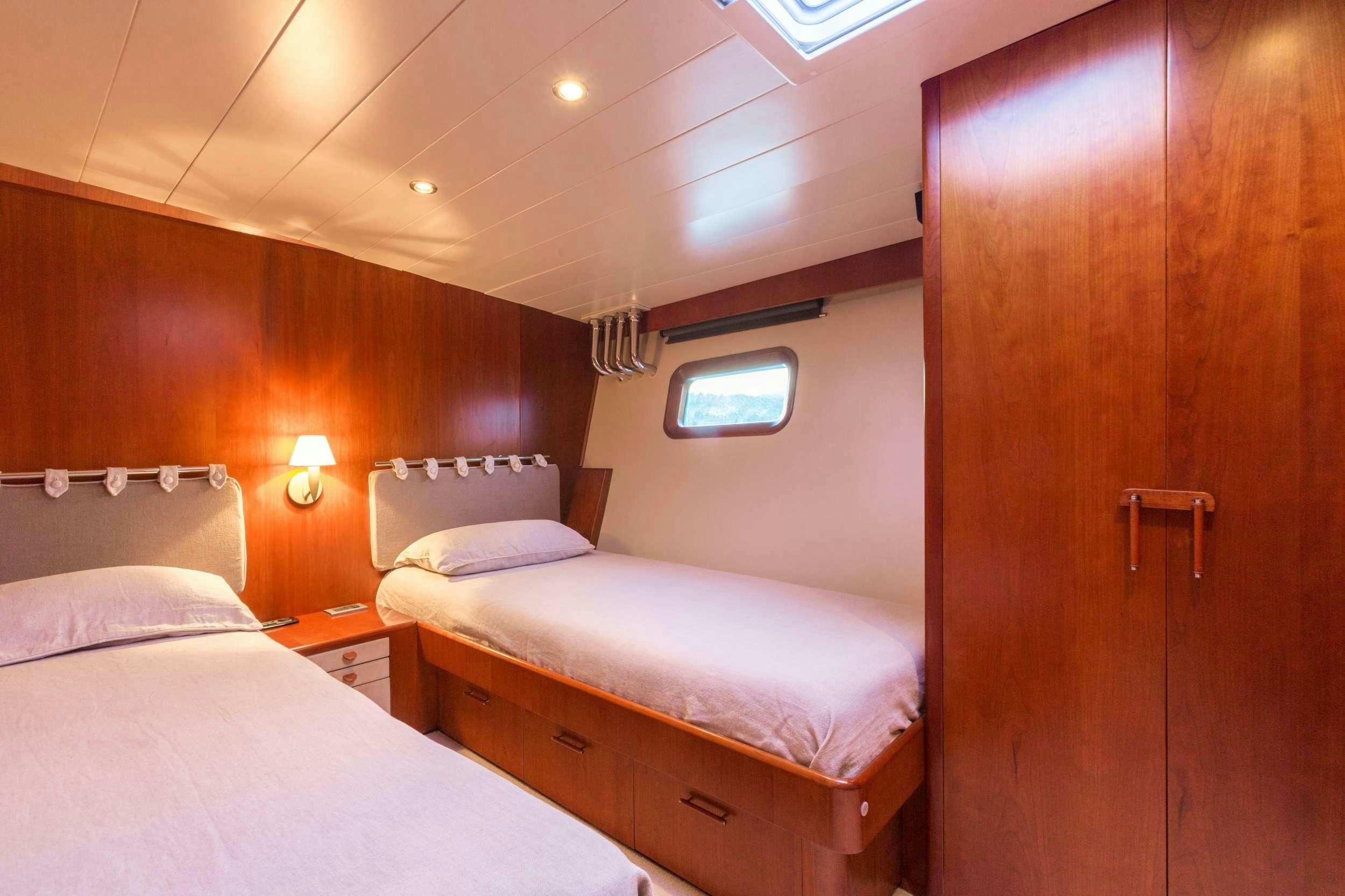 a room with two beds aboard Free at Last Yacht for Charter