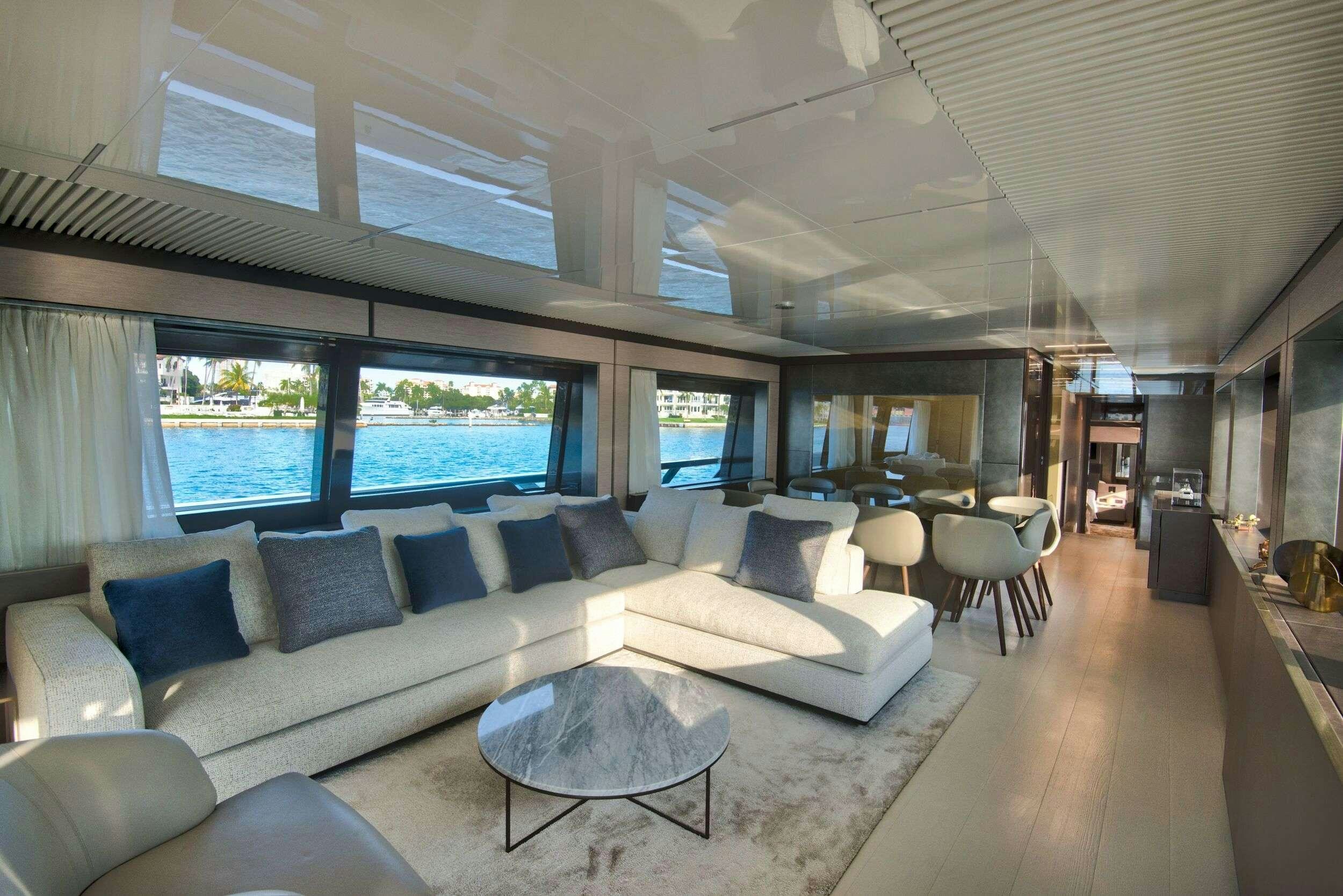 a living room with a large window aboard 92' FERRETTI Yacht for Charter