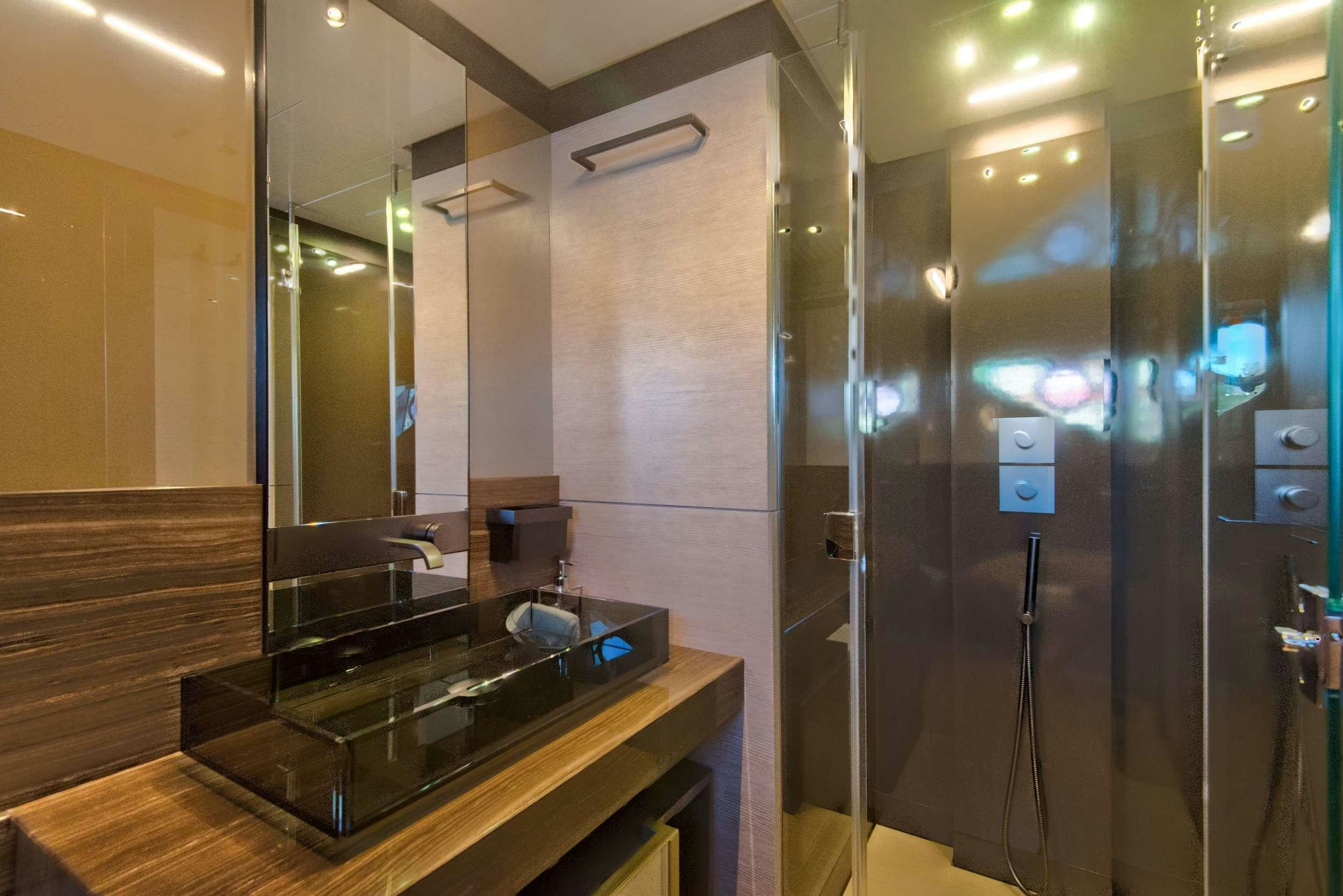 a bathroom with a countertop sink and mirror aboard 92' FERRETTI Yacht for Charter