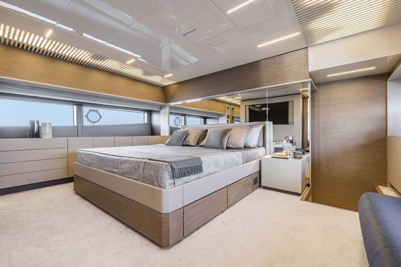 a large bed in a room aboard 92' FERRETTI Yacht for Charter