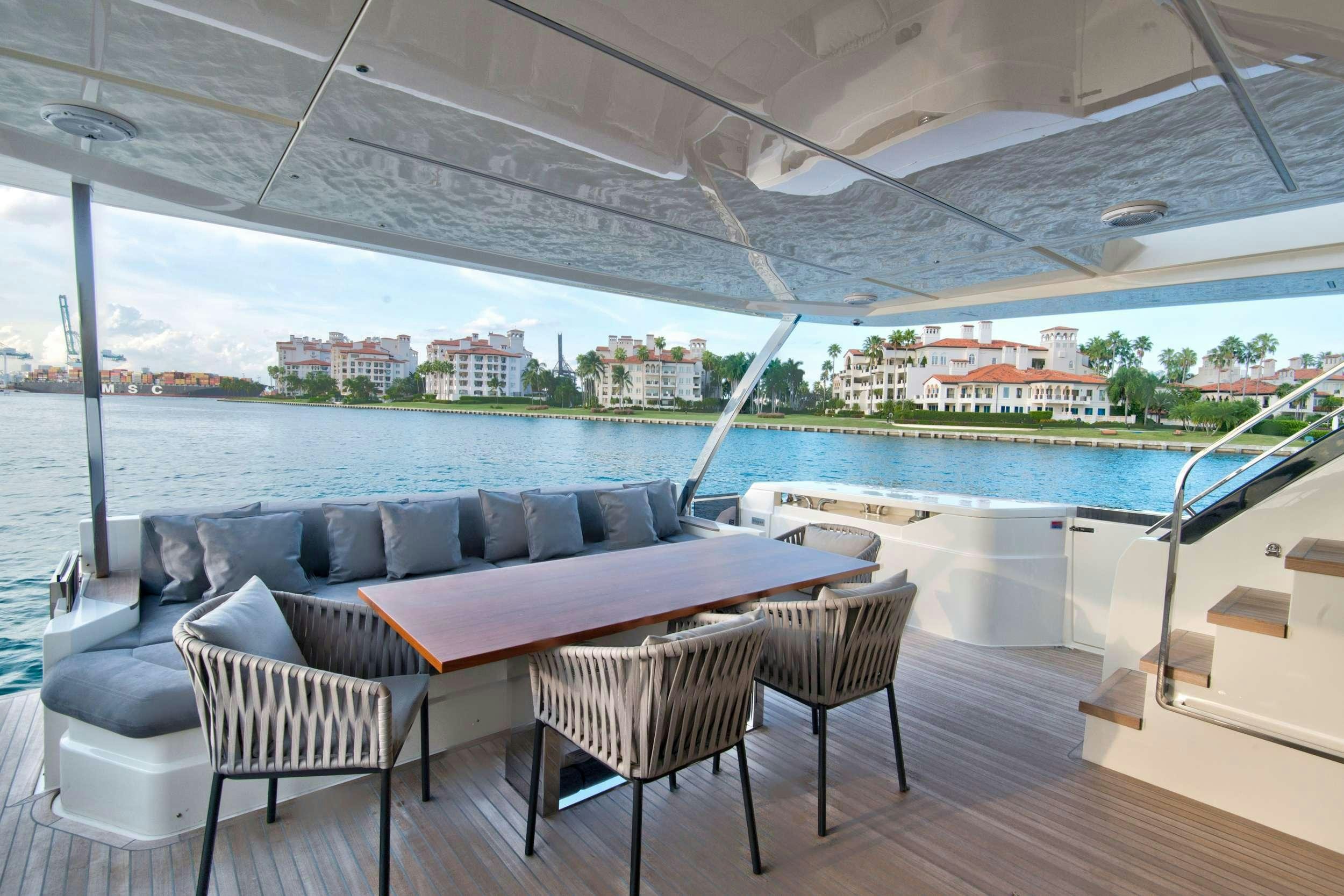 a couch and chairs on a deck aboard 92' FERRETTI Yacht for Charter