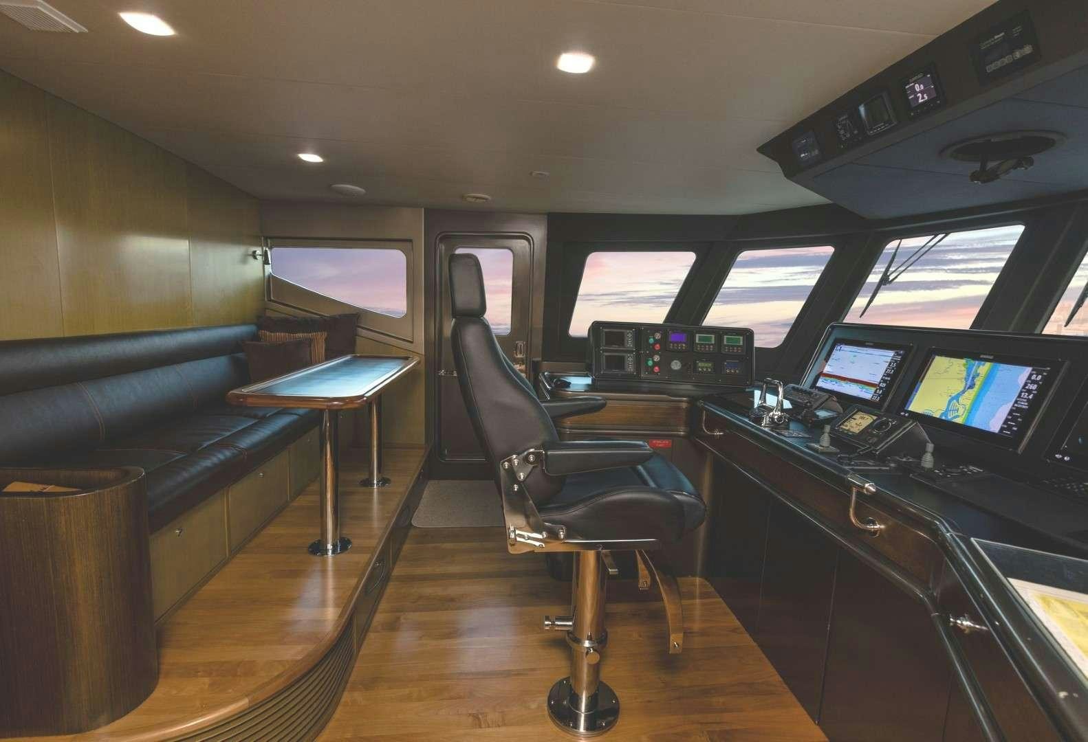 a room with a desk and chairs aboard TEXAS T Yacht for Charter