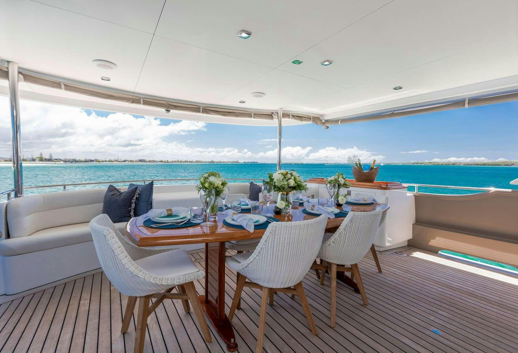 a table and chairs on a deck aboard TEXAS T Yacht for Charter