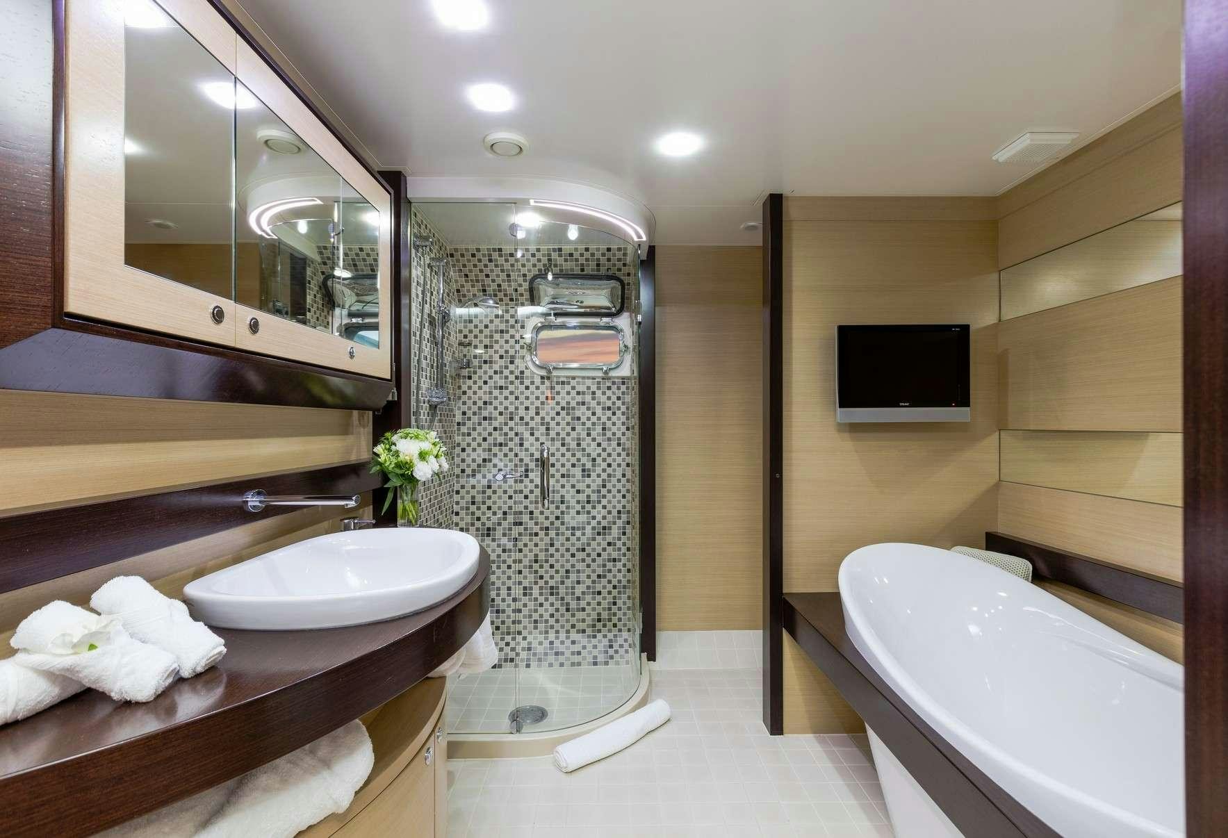 a bathroom with a sink and a bathtub aboard TEXAS T Yacht for Charter