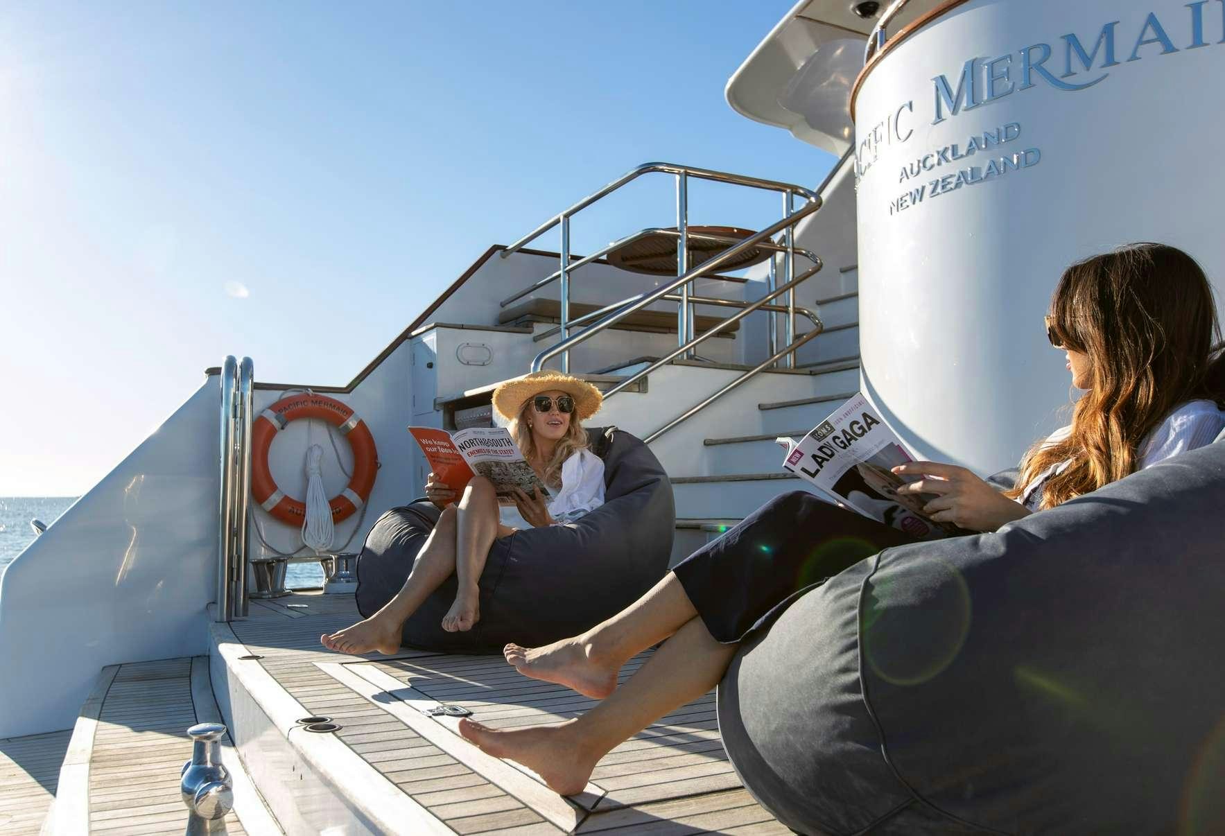 a person sitting on a boat aboard PACIFIC MERMAID Yacht for Charter
